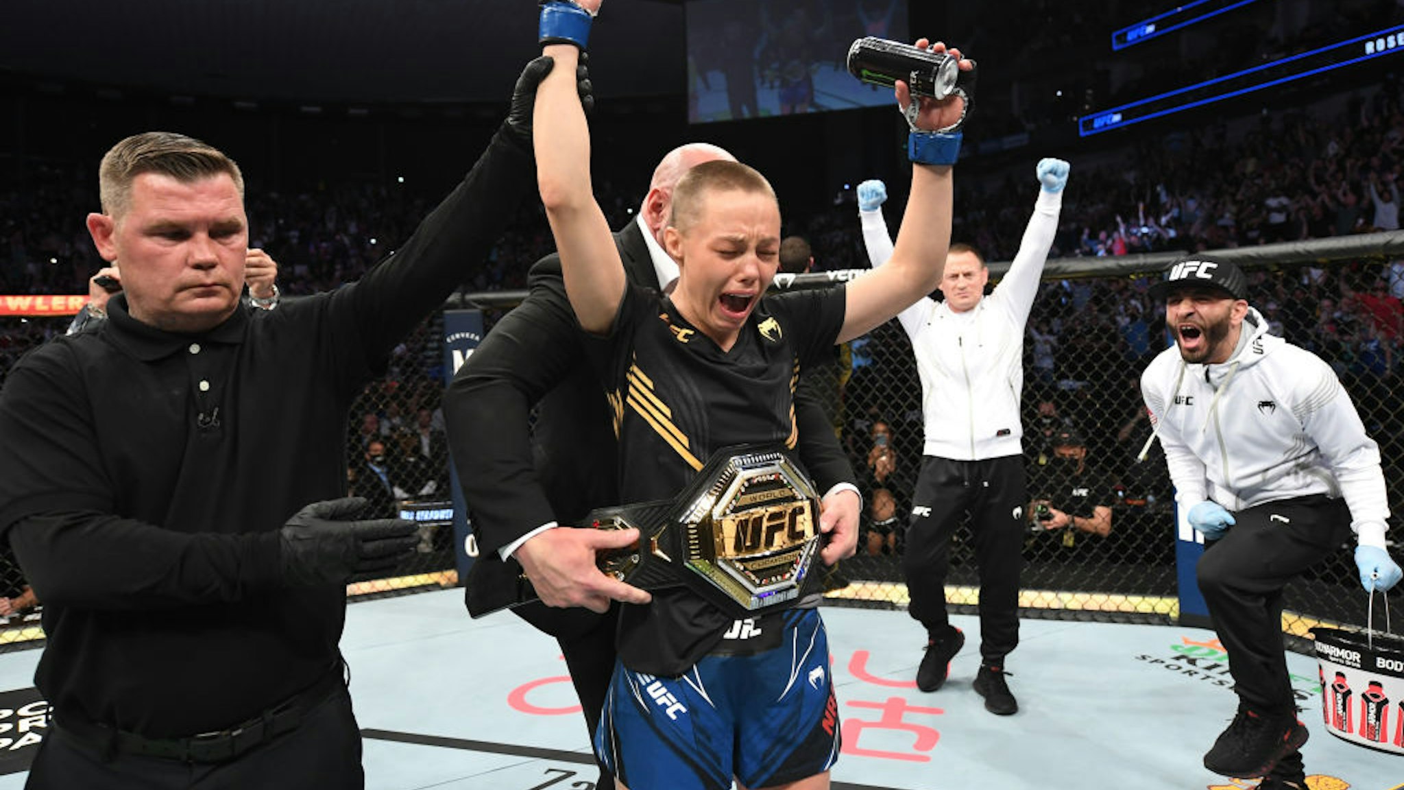 JACKSONVILLE, FLORIDA - APRIL 24: Rose Namajunas reacts after defeating Zhang Weili of China in their UFC women's strawweight championship bout as UFC President Dana White places the championship belt on her during the UFC 261 event at VyStar Veterans Memorial Arena on April 24, 2021 in Jacksonville, Florida. (Photo by Josh Hedges/Zuffa LLC)