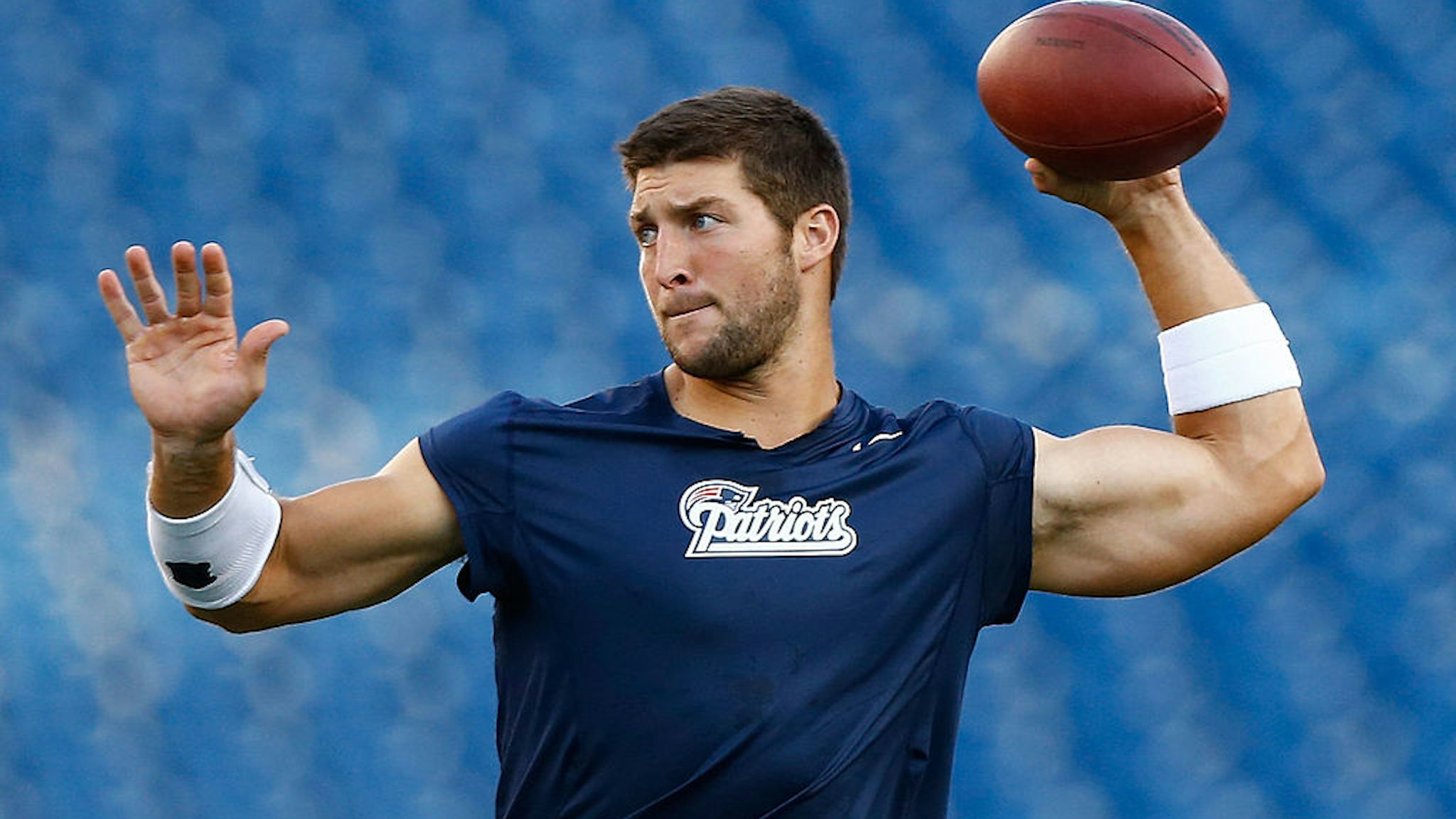 FOXBORO, MA - AUGUST 16: Tim Tebow #5 of the New England Patriots warms up prior to the game against the Tampa Bay Buccaneers at Gillette Stadium on August 16, 2013 in Foxboro, Massachusetts. (Photo by Jared Wickerham/Getty Images)