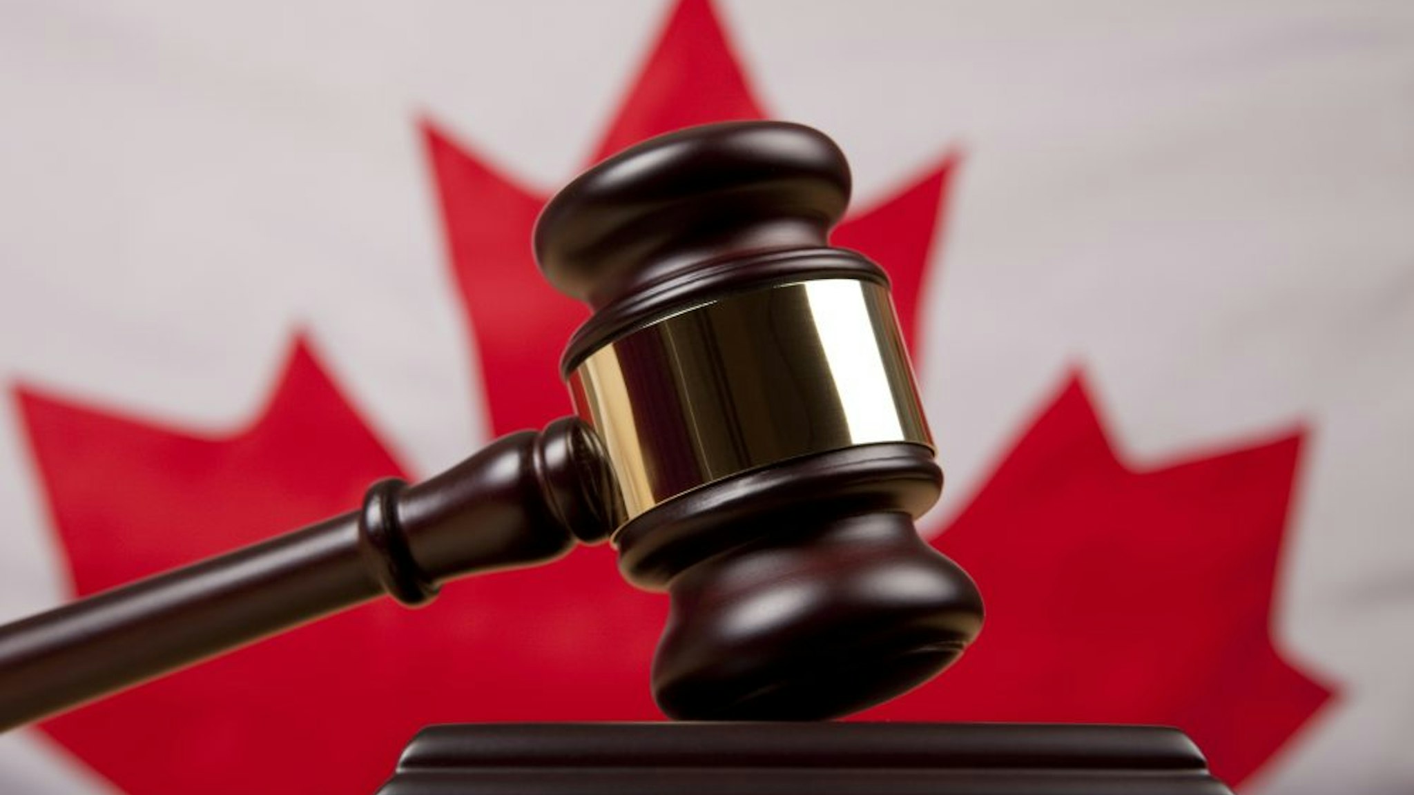 Gavel In Front Of Canadian Flag