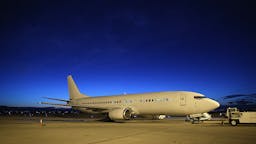 ICE Deports Undocumented Immigrants Via ICE Air MESA, AZ - OCTOBER 15: An Immigration and Customs Enforcement (ICE), charter jet wait to depart on October 15, 2015 in Mesa, Arizona. The plane, carrying undocumented immigrants, flew to other states for follow-on ICE deportation flights to the Caribbean, Mexico and Central America. ICE builds deportation cases against thousands of undocumented immigrants, many of whom, they say, have criminal records. The number of ICE detentions and deportations has dropped in the last two years since some states adopted laws limiting how state law enforcement agencies cooperate with federal immigration authorities. (Photo by John Moore/Getty Images)