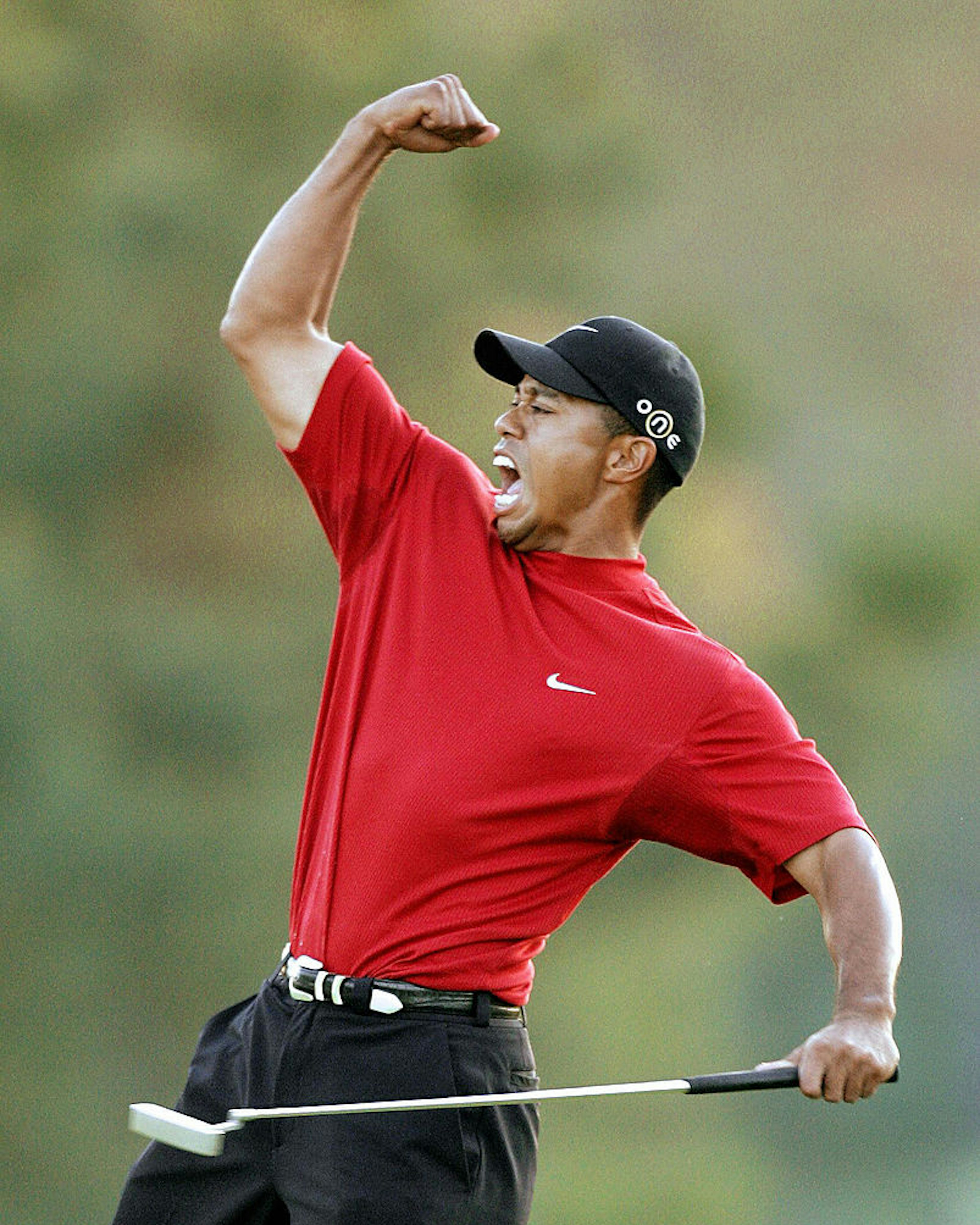 AUGUSTA, UNITED STATES: Tiger Woods of the US celebrates winning the 2005 Masters Golf Tournament Championship 10 April 2005 at the Augusta National Golf Club in Augusta, Ga. Woods defeated fellow American Chris DiMarco in a one-hole play-off. AFP PHOTO/Jeff HAYNES (Photo credit should read JEFF HAYNES/AFP via Getty Images)