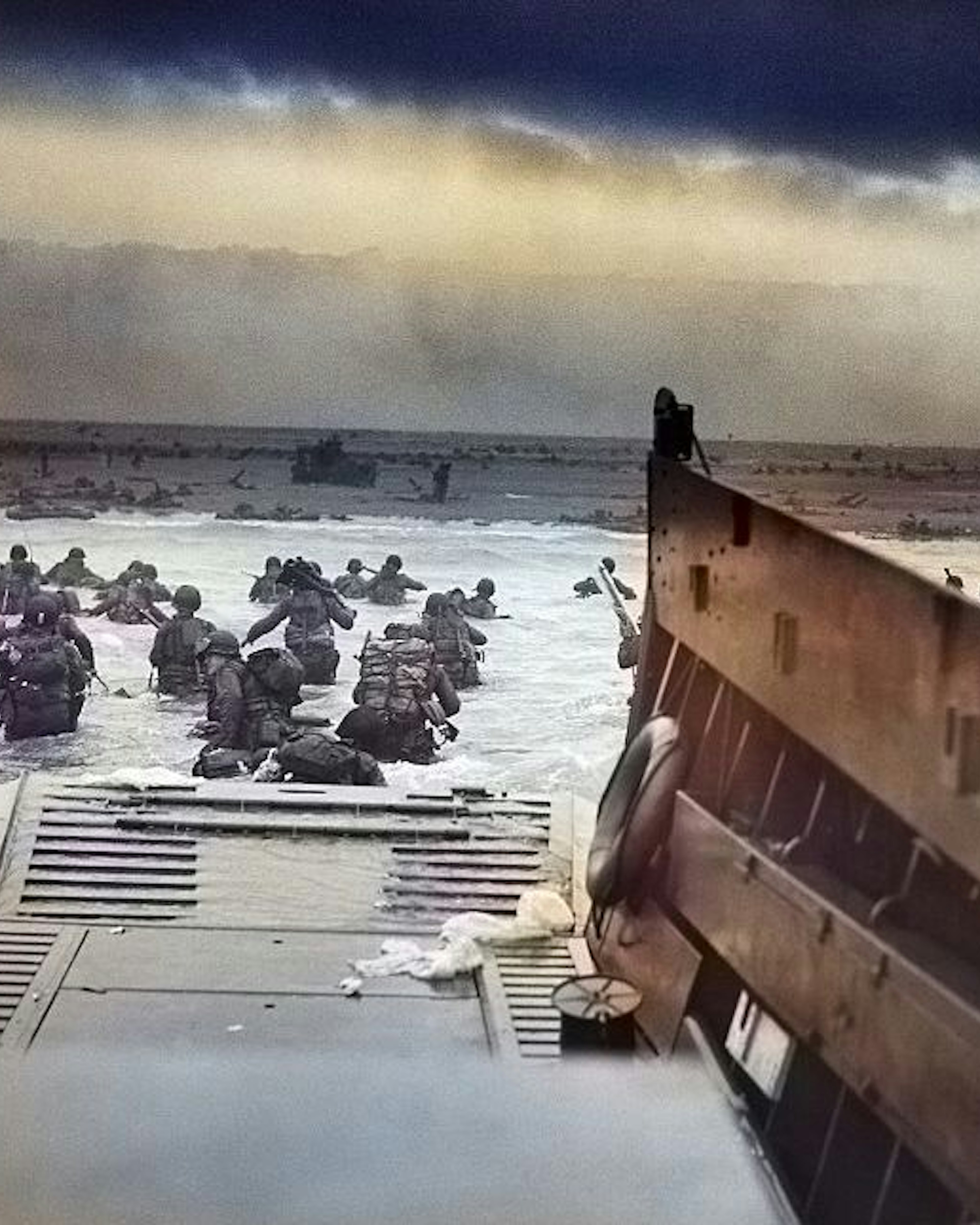 Digitally colorized image of "Into the Jaws of Death", a photograph by Robert F Sargent of the United States Army First Infantry Division disembarking from an LCVP (landing craft) onto Omaha Beach during the Normandy Landings on D Day during World War 2, June 6, 1944. (Photo via Smith Collection/Gado/Getty Images).