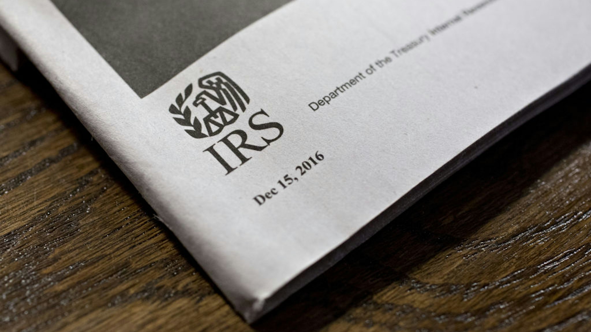 A U.S. Department of the Treasury Internal Revenue Service (IRS) logo is seen on an instruction book for a 1040 Individual Income Tax forms in Tiskilwa, Illinois, U.S., on Tuesday, March 28, 2017. Due to the Emancipation day holiday, this year's income taxes will need to be filed by April 18 instead of April 15. Photographer: Daniel Acker/Bloomberg via Getty Images
