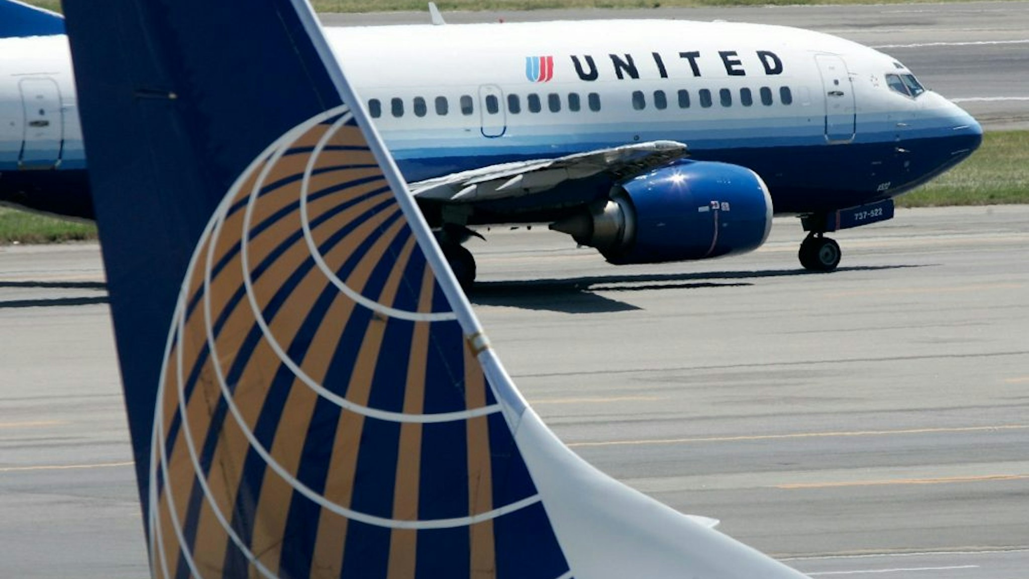 WASHINGTON - AUGUST 16: A United Airlines aircraft passes by a Continental Airlines aircraft as it taxis to takeoff from the runway of Ronald Reagan National Airport August 16, 2006 in Washington, DC.