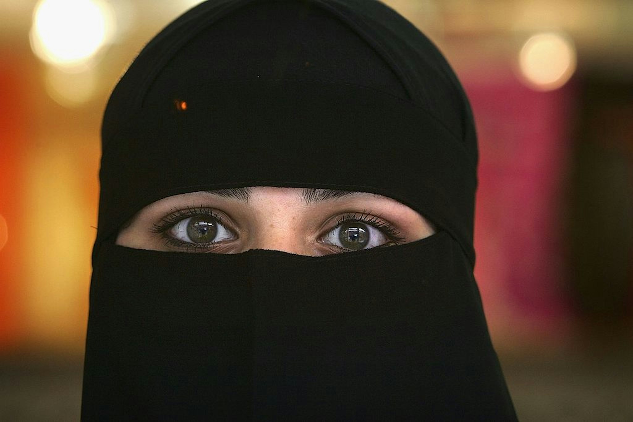 BLACKBURN, UNITED KINGDOM - OCTOBER 06: A Muslim woman wearing a Niqab poses inside an Asian fashion shop in the British northern town of Blackburn, the constituency of Member of Parliament Jack Straw, where a quarter of his constituents are Muslim on October 6, 2006, Blackburn, England. Leader of the House of Commons Jack Straw has said that he asked Muslim women attending his Blackburn constituency surgeries if they would mind removing veils. The comments have caused anger within the Muslim community.