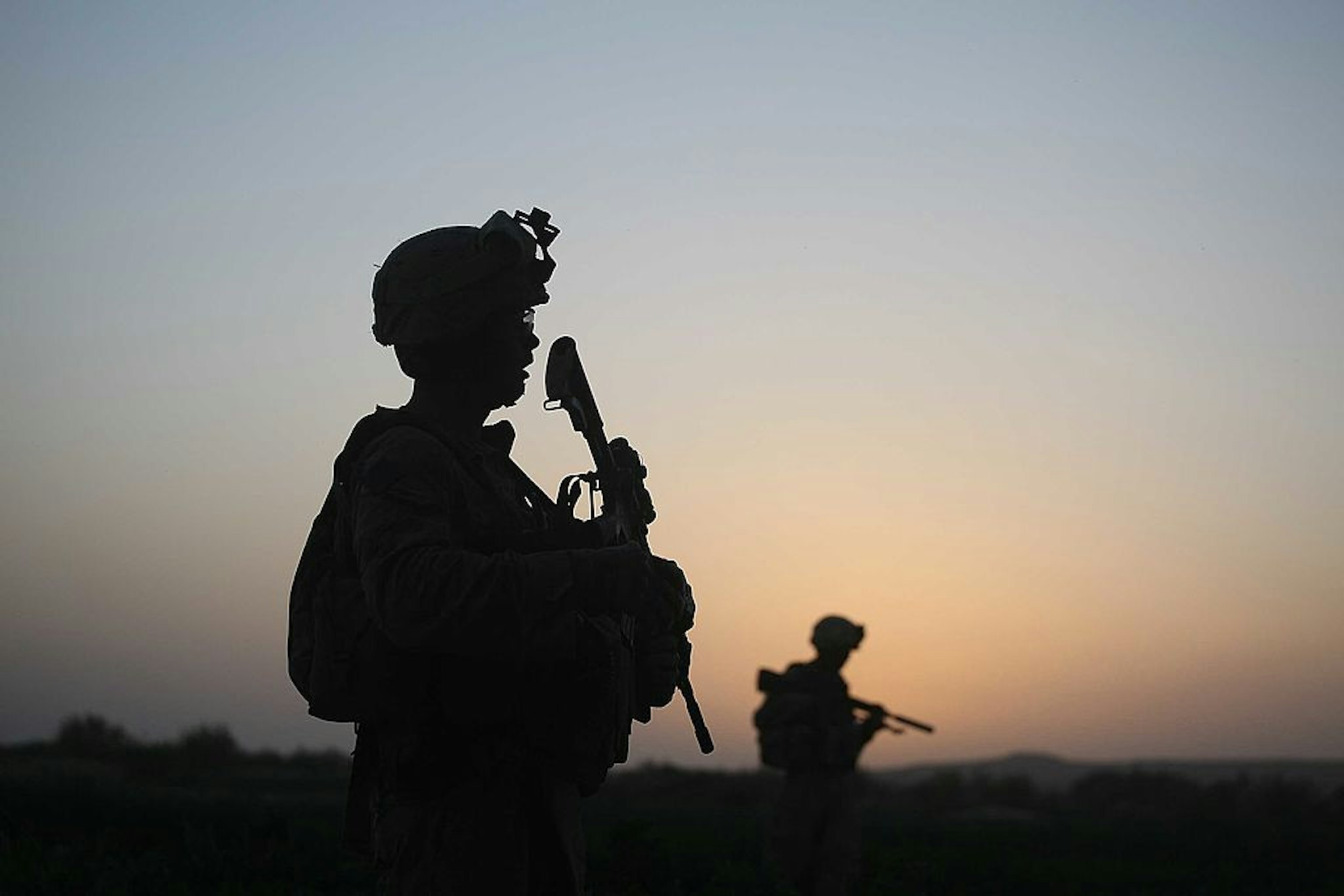 HERATI, AFGHANISTAN- JULY 18: U.S. Marines with the 2nd Marine Expeditionary Brigade, RCT 2nd Battalion 8th Marines Echo Co. step off in the early morning during an operation to push out Taliban fighters on July 18, 2009 in Herati, Afghanistan . The Marines met no resistance during the operatoin. The Marines are part of Operation Khanjari which was launched to take areas in the Southern Helmand Province that Taliban fighters are using as a resupply route and to help the local Afghan population prepare for the upcoming presidential elections. (Photo by Joe Raedle/Getty Images)