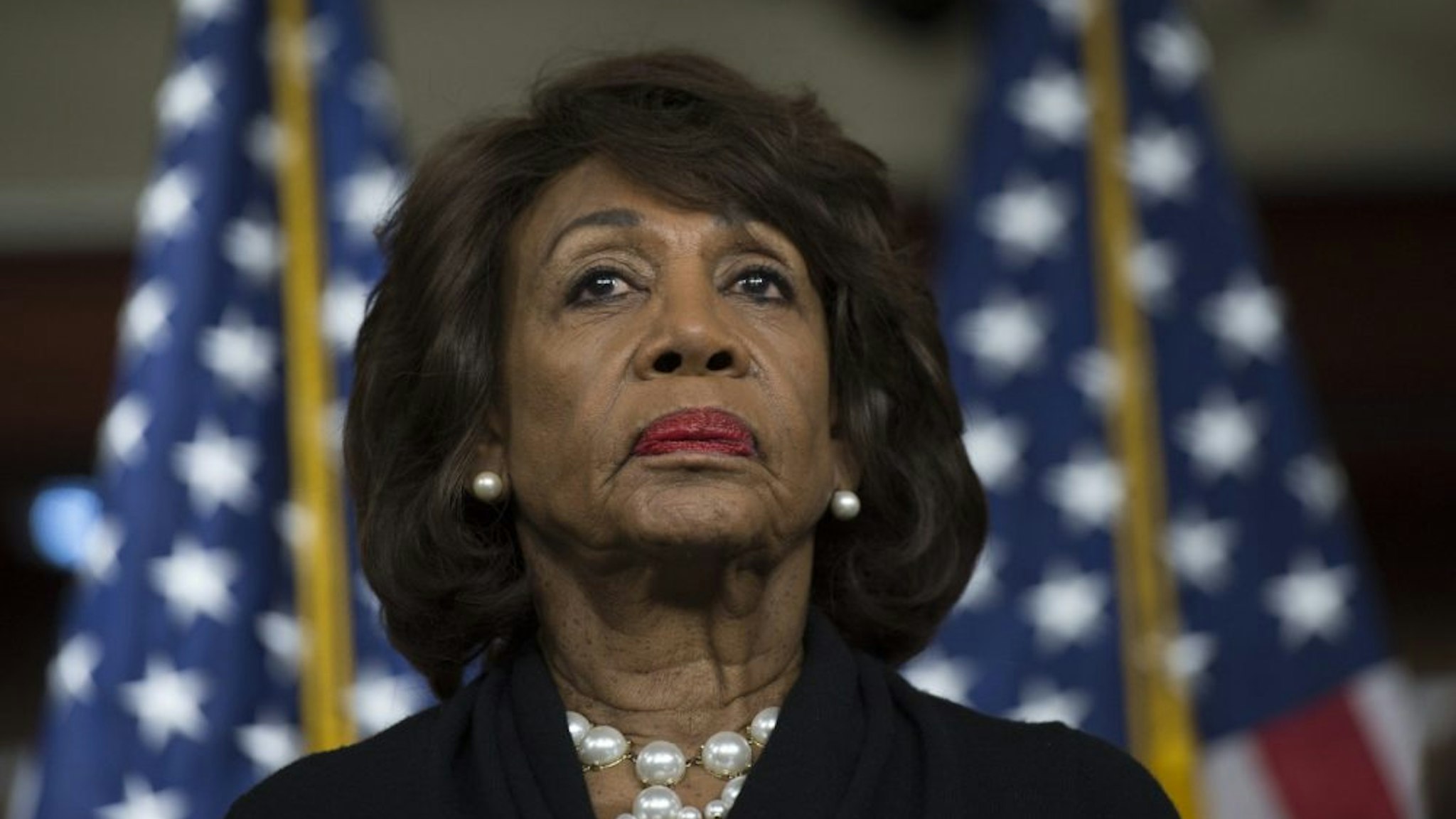US Representative Maxine Waters (D-CA) looks on before speaking to reports regarding the Russia investigation on Capitol Hill in Washington, DC on January 9, 2018.