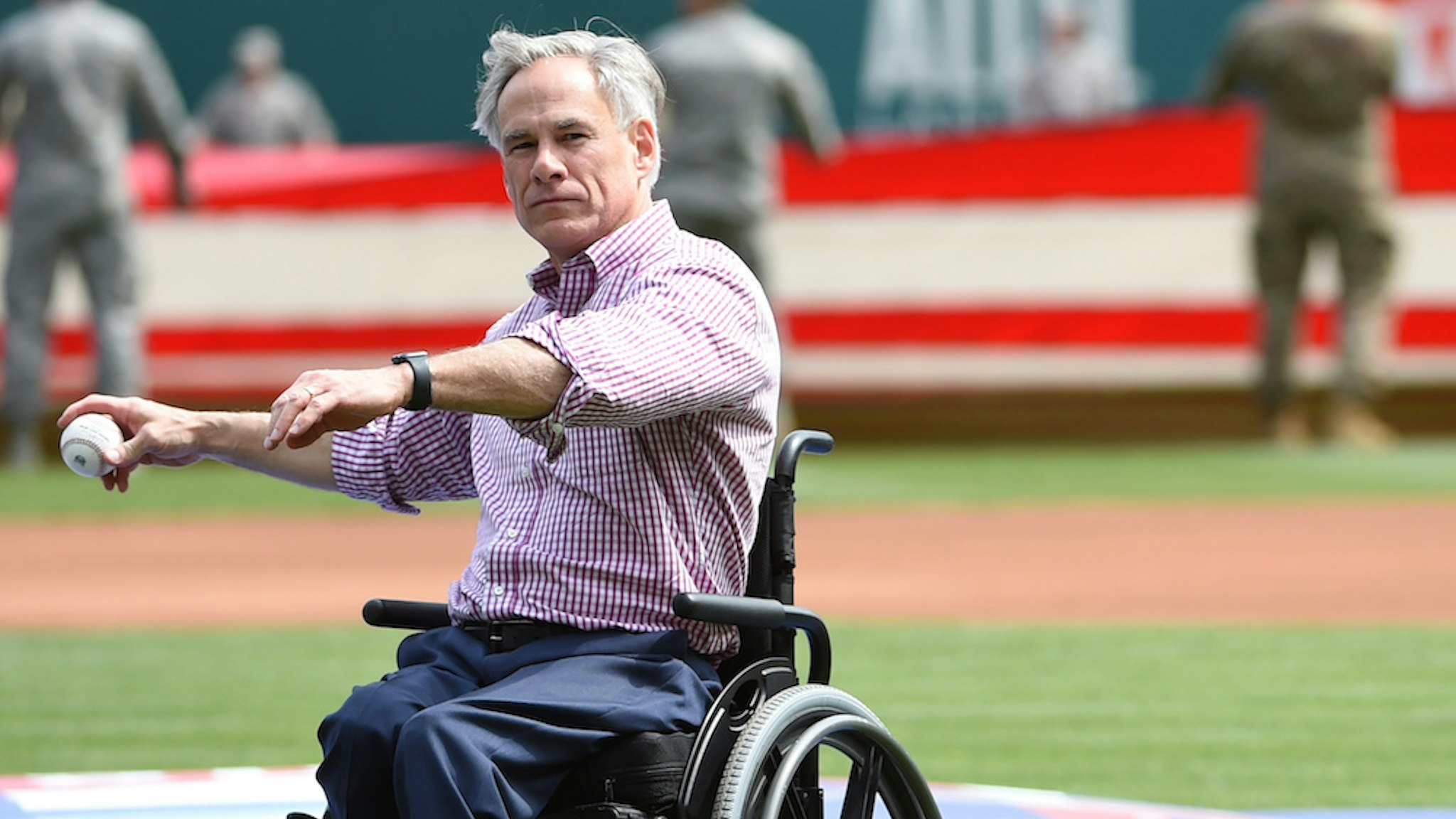ARLINGTON, TX - MARCH 28: Texas Governor Greg Abbott throws out the ceremonial first pitch before the game between the Chicago Cubs and the Texas Rangers at Globe Life Park in Arlington on Thursday, March 28, 2019 in Arlington, Texas. (Photo by Cooper Neill/MLB Photos via Getty Images)