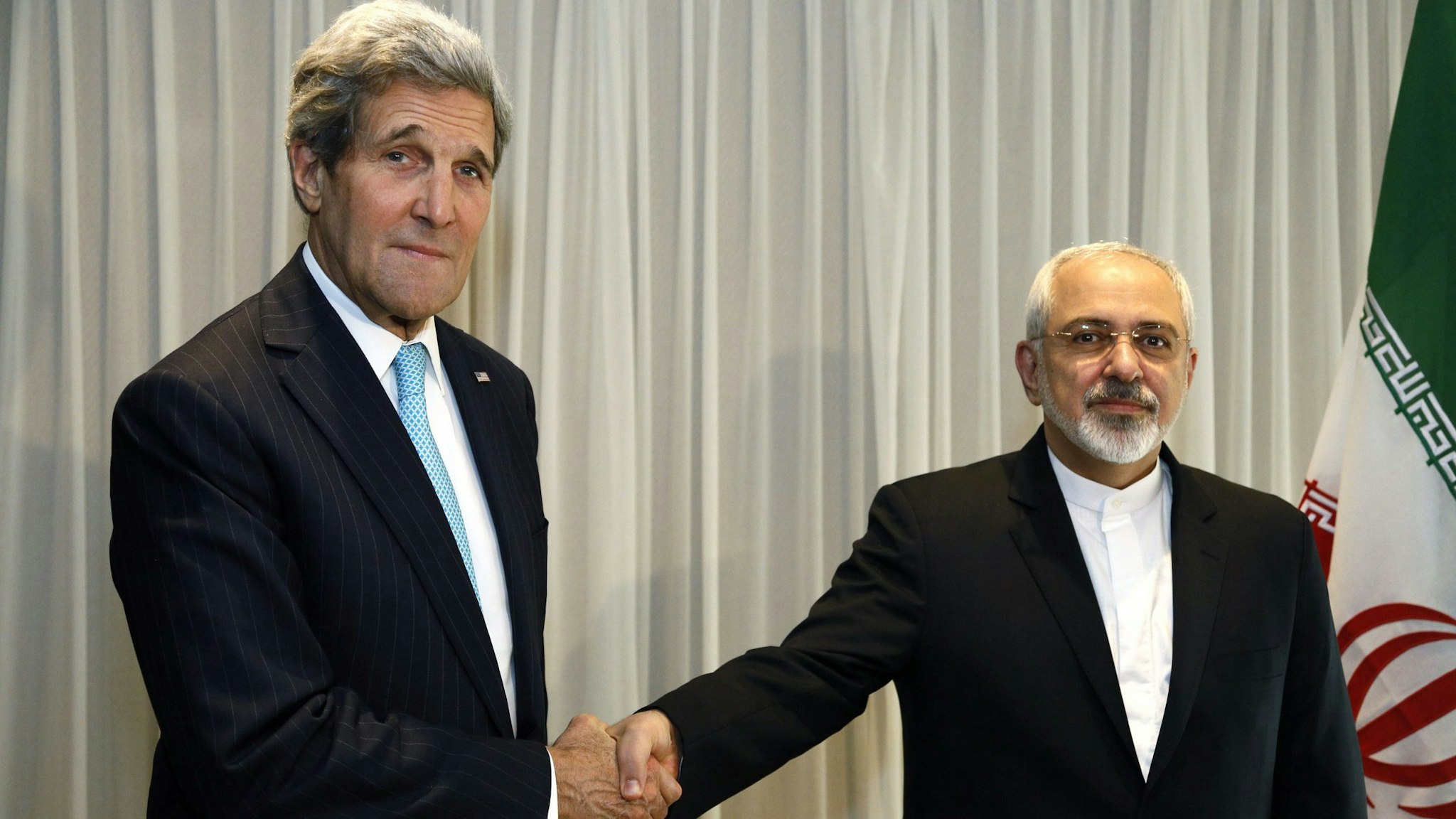 Iranian Foreign Minister Mohammad Javad Zarif shakes hands on January 14, 2015 with US State Secretary John Kerry in Geneva. Zarif said on January 14 that his meeting with his US counterpart was vital for progress on talks on Tehran's contested nuclear drive. Under an interim deal agreed in November 2013, Iran's stock of fissile material has been diluted from 20 percent enriched uranium to five percent, in exchange for limited sanctions relief.