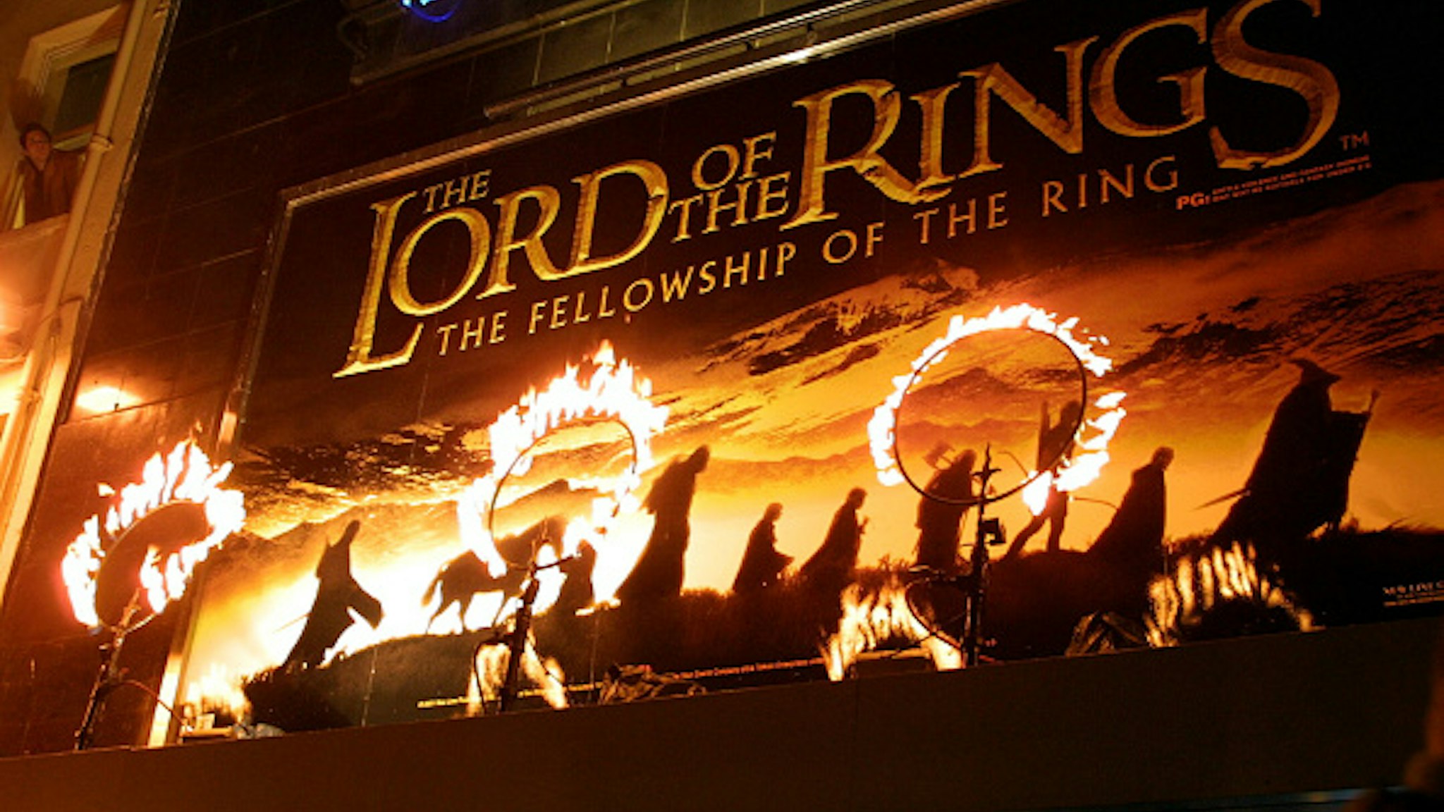 Rings of fire burn near the movie poster for the film "The Lord of the Rings: The Fellowship of the Ring." The stars of the film attended the premiere in London.Stephane