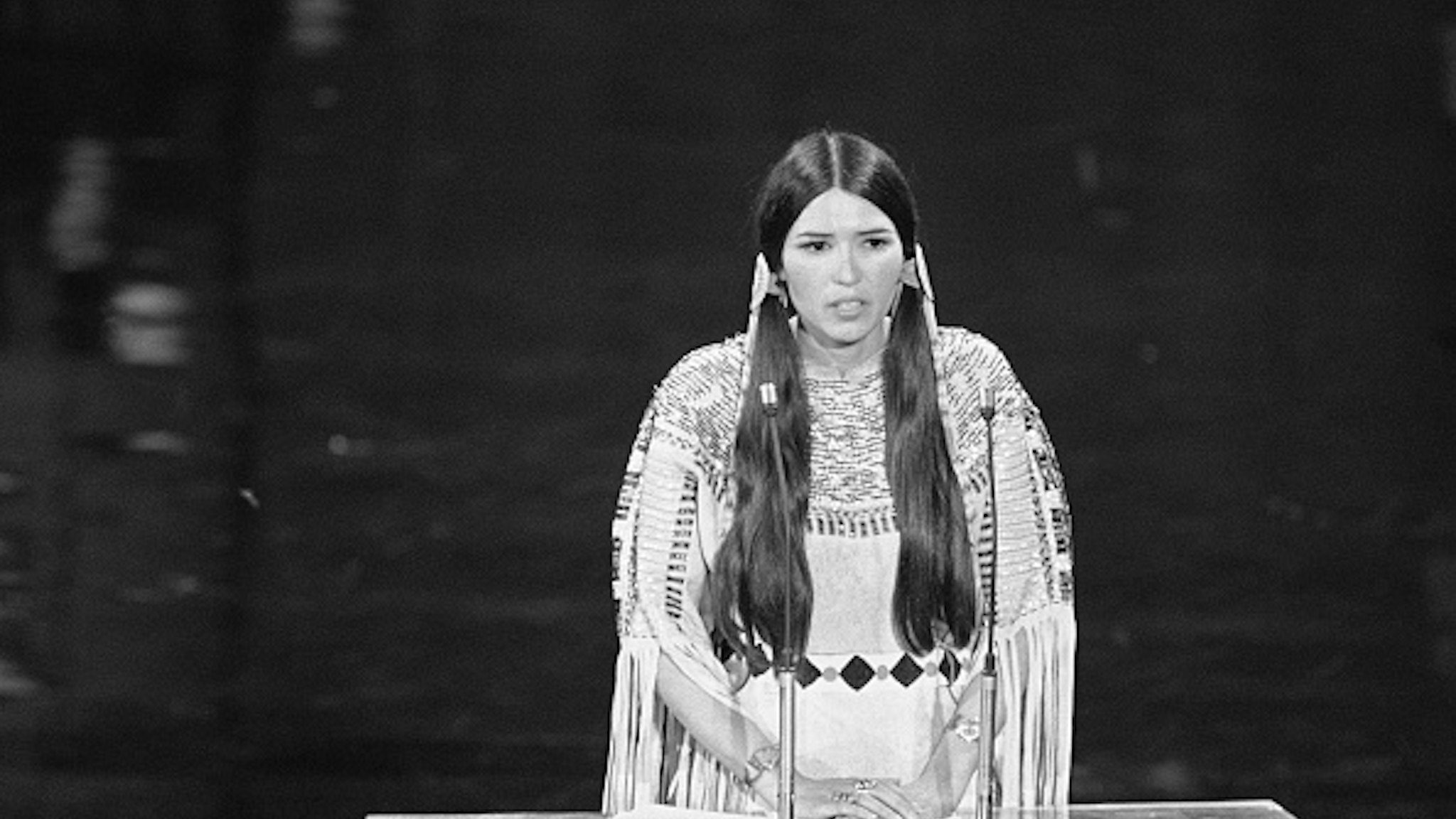 Native American Sacheen Littlefeather speaks at the 45th Academy Awards. On behalf of Marlon Brando, she refused the Best Actor award he was awarded for his role in Godfather. Brando refused the award because of the treatment by the Americans of the American Indian.