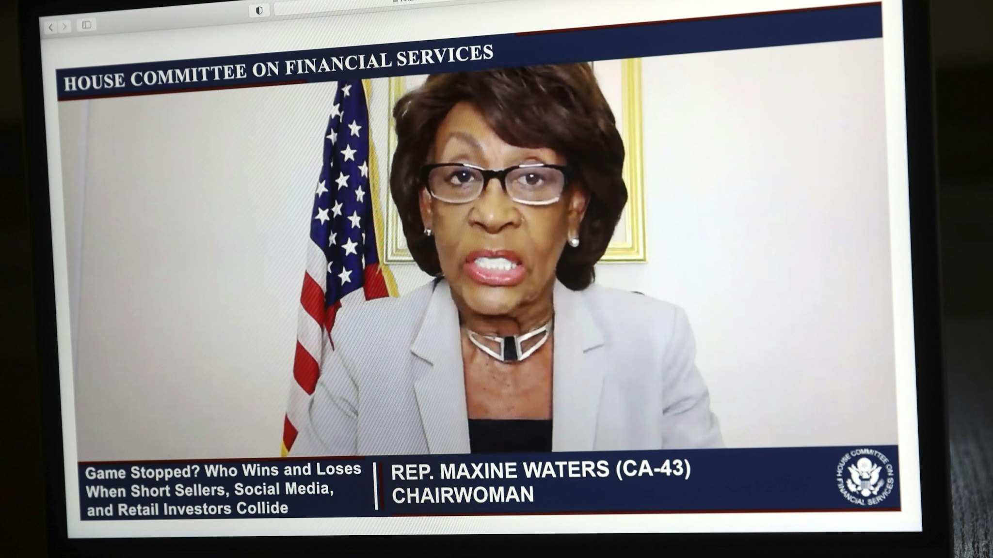 Representative Maxine Waters, a Democrat from California and chairwoman of the House Financial Services Committee, speaks virtually during a hearing on a laptop computer in Tiskilwa, Illinois, U.S., on Thursday, Feb. 18, 2021. Robinhood Markets and Citadel, central players in the GameStop Corp. saga that riveted markets last month plan to deliver a unified message to U.S. lawmakers that conspiracies swirling in Washington, that they worked together to harm retail investors are categorically false.