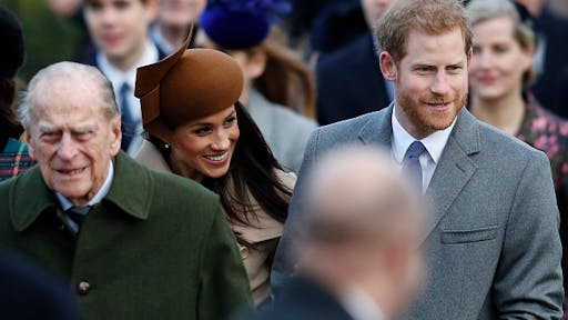 BRITAIN-ROYALS-CHRISTMAS (L-R) Britain's Prince Philip, Duke of Edinburgh, US actress and fiancee of Britain's Prince Harry Meghan Markle and Britain's Prince Harry (R) arrive to attend the Royal Family's traditional Christmas Day church service at St Mary Magdalene Church in Sandringham, Norfolk, eastern England, on December 25, 2017.