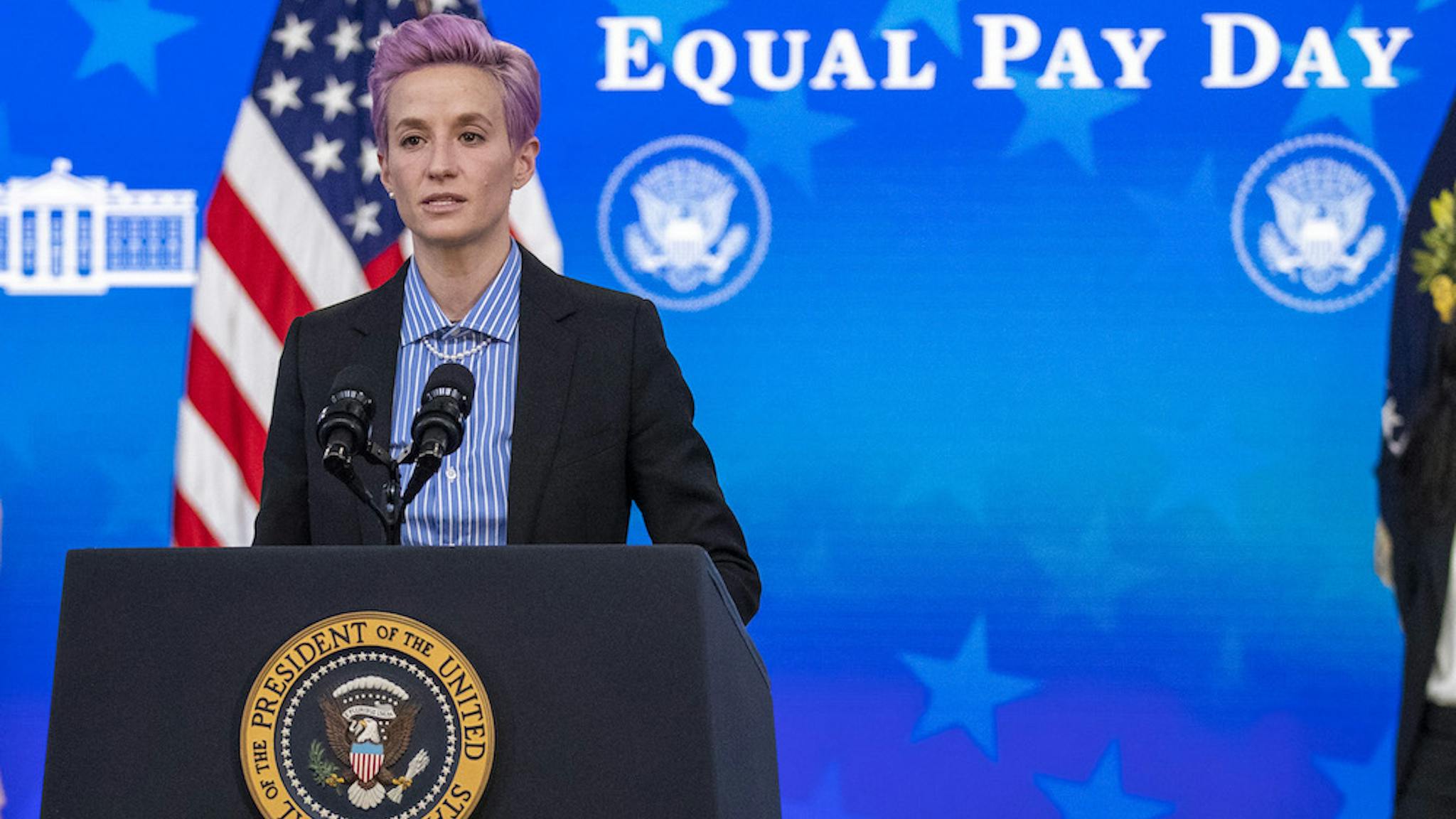 Megan Rapinoe Megan Rapinoe, player with the U.S. Women's National Soccer Team, speaks as U.S. President Joe Biden and First Lady Jill Biden listen during an event marking Equal Pay Day in the Eisenhower Executive Office Building in Washington, D.C., U.S., on Wednesday, March 24, 2021. The Biden administration has signaled plans to strengthen gender equity at a time when women in the U.S. are disproportionately exiting the workforce compared with men during the Covid-19 pandemic, and are paid about 82 cents on the dollar compared with men. Photographer: Shawn Thew/EPA/Bloomberg