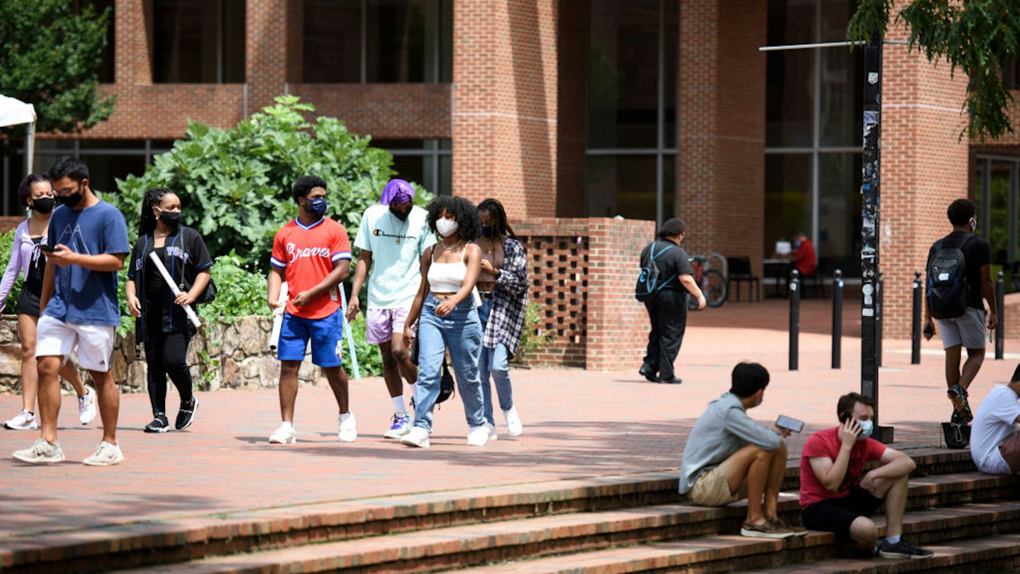CHAPEL HILL, NC - AUGUST 18: Students walk through the campus of the University of North Carolina at Chapel Hill on August 18, 2020 in Chapel Hill, North Carolina.The school halted in-person classes and reverted back to online courses after a rise in the number of COVID-19 cases over the past week.