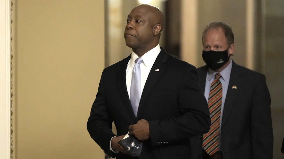 WASHINGTON, DC - APRIL 28: Sen. Tim Scott (R-SC) walks through the U.S. Capitol before he delivers the republican response to President Biden's address to congress April 28, 2021 in Washington, DC. On the eve of his 100th day in office, Biden spoke about his plan to revive America’s economy and health as it continues to recover from a devastating pandemic. He delivered his speech before 200 invited lawmakers and other government officials instead of the normal 1600 guests because of the ongoing COVID-19 pandemic.