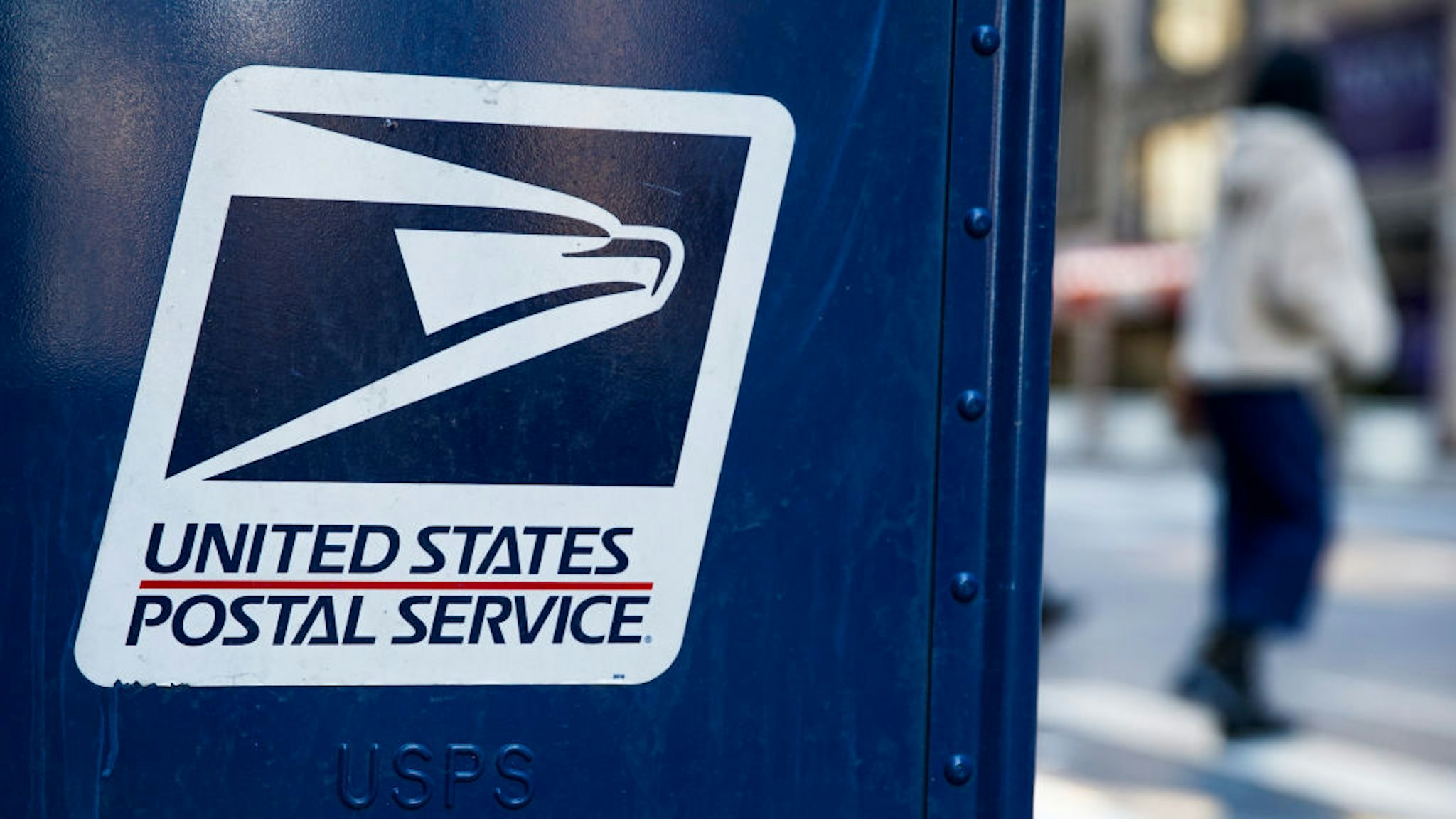 NEW YORK, NEW YORK - FEBRUARY 24: A USPS logo is seen on a mailbox on February 24, 2021, in New York City. The U.S Postal Service awarded a 10-year multi-billion dollar contract to Wisconsin-based Oshkosh Defense to replace its vehicles. (Photo by John Smith/VIEWpress via Getty Images)