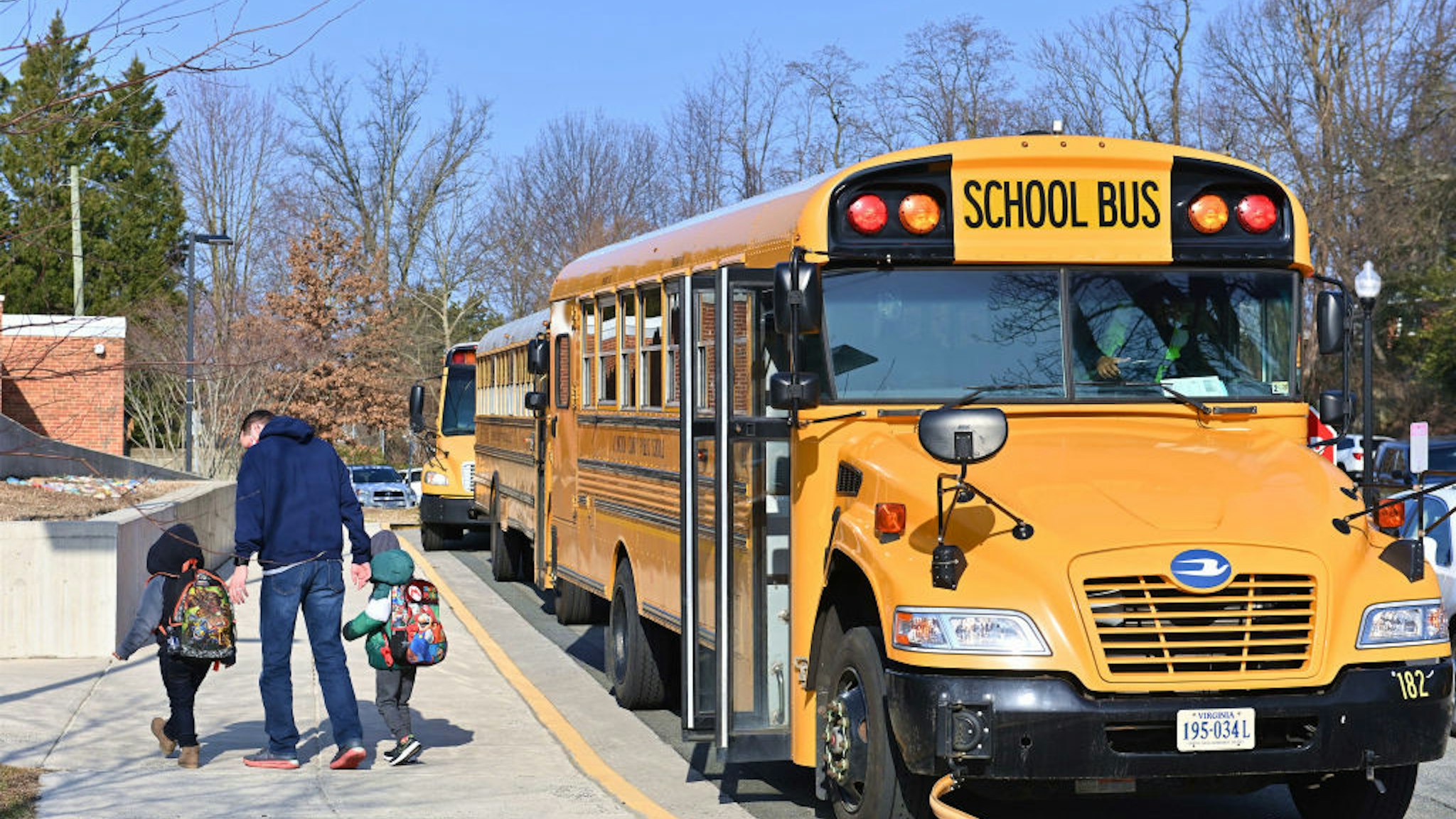 ARLINGTON, VA - MARCH 04: A school bus arrives at Ashlawn elementary school on March 4, 2021 in Arlington, VA. Ashlawn elementary school reopens on Thursday in Arlington.