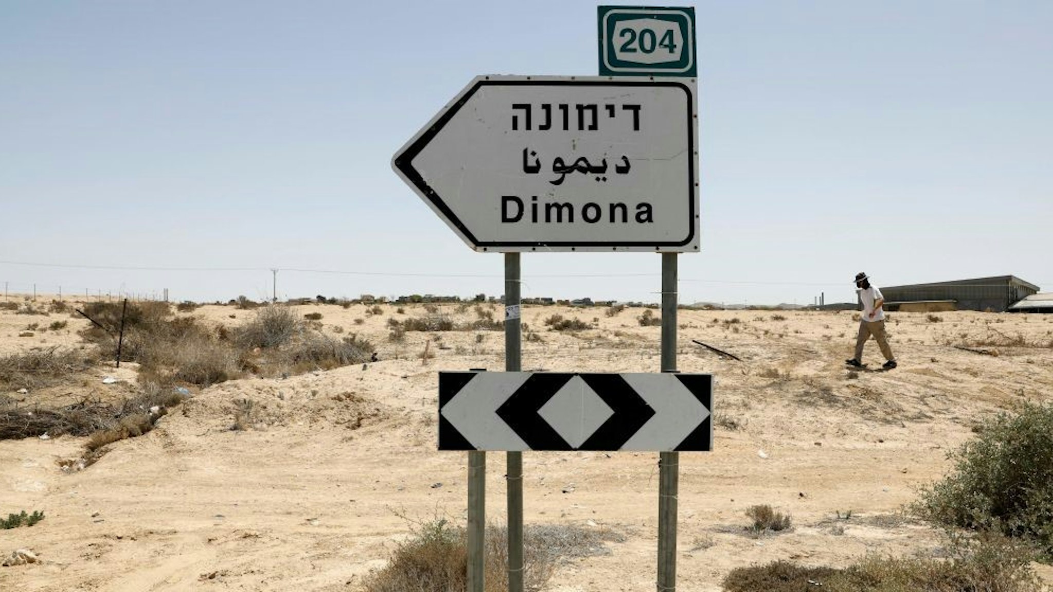 This picture taken on April 22, 2021 shows a view of a road sign directing towards the city of Dimona, close to the nuclear power plant in the southern Israeli Negev desert. (Photo by Ahmad GHARABLI / AFP) (Photo by