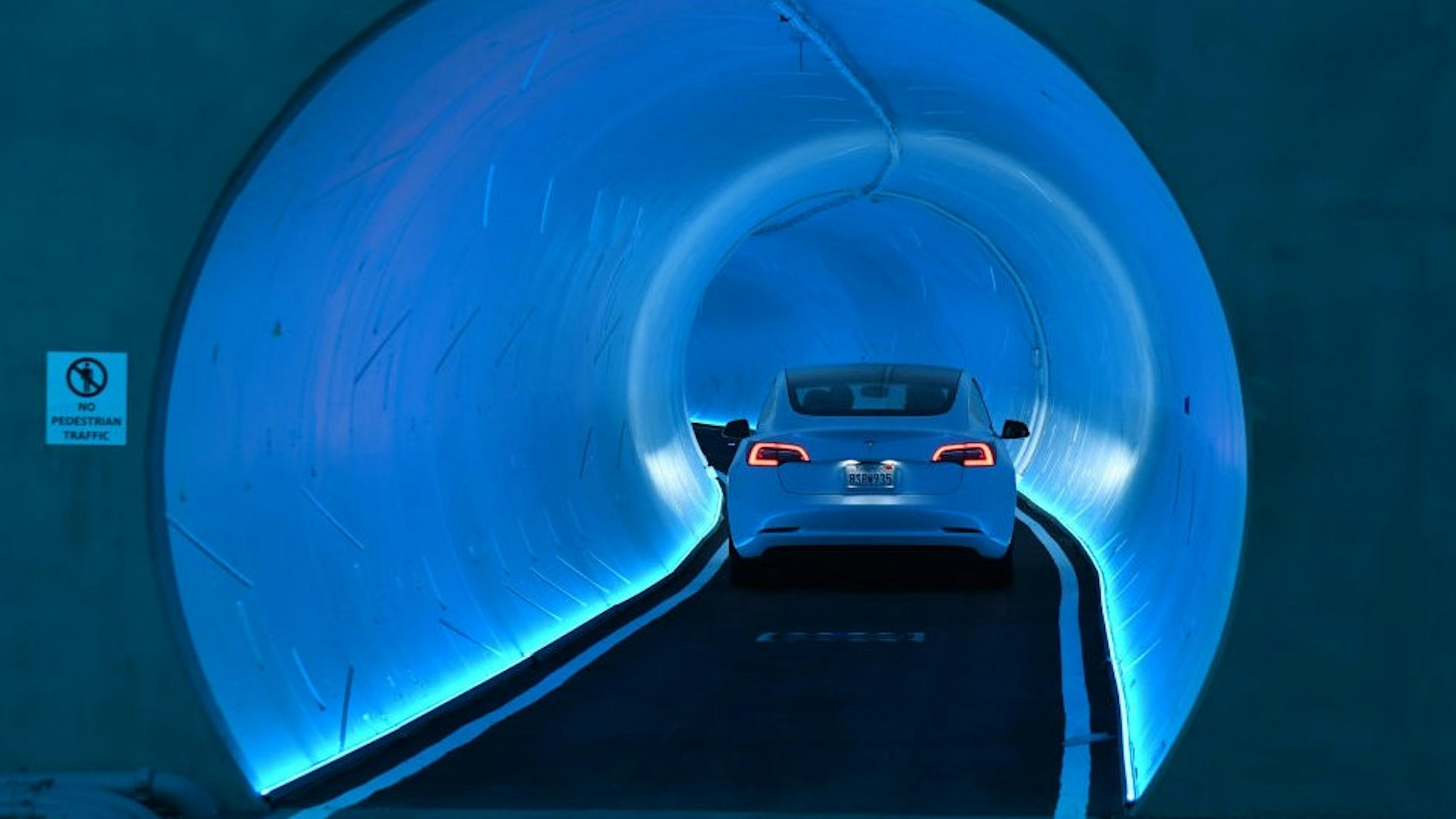 LAS VEGAS, NEVADA - APRIL 09: A Tesla car drives through a tunnel in the Central Station during a media preview of the Las Vegas Convention Center Loop on April 9, 2021 in Las Vegas, Nevada. The Las Vegas Convention Center Loop is an underground transportation system that is the first commercial project by Elon Musk’s The Boring Company. The USD 52.5 million loop, which includes two one-way vehicle tunnels 40 feet beneath the ground and three passenger stations, will take convention attendees across the 200-acre convention campus for free in all-electric Tesla vehicles in under two minutes. To walk that distance can take upward of 25 minutes. The system is designed to carry 4,400 people per hour using a fleet of 62 vehicles at maximum capacity. It is scheduled to be fully operational in June when the facility plans to host its first large-scale convention since the COVID-19 shutdown. There are plans to expand the system throughout the resort corridor in the future. (Photo by
