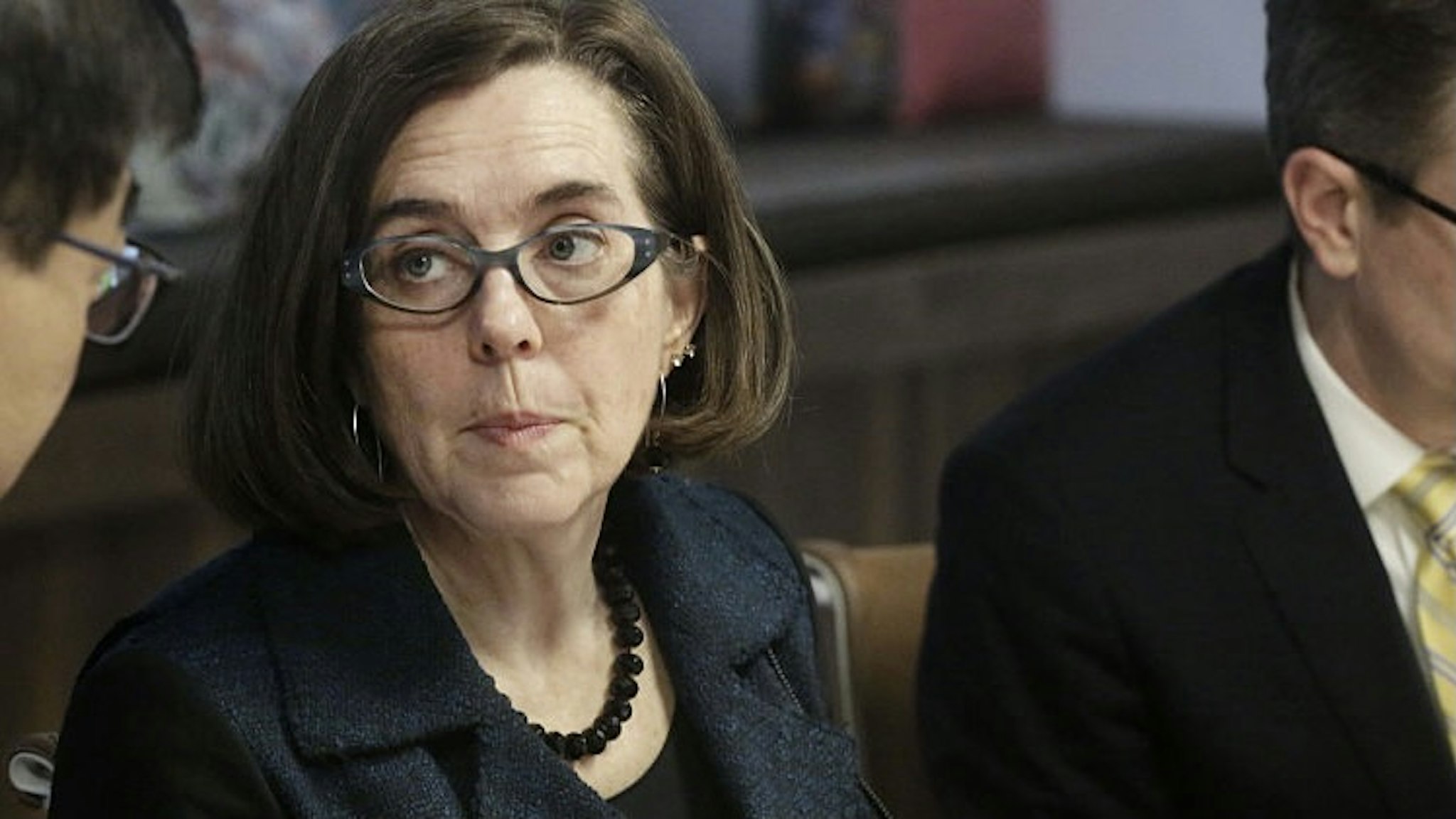 Oregon Governor Kate Brown Interview Kate Brown, governor of Oregon, center, listens during an interview in Portland, Oregon, U.S. on Wednesday, Jan. 20, 2016. Brown, a Democrat, joined the state House of Representatives in 1991, was later elected to the Senate and served as secretary of state since 2009, before taking over as governor in February. Photographer: Meg Roussos/Bloomberg via Getty Images