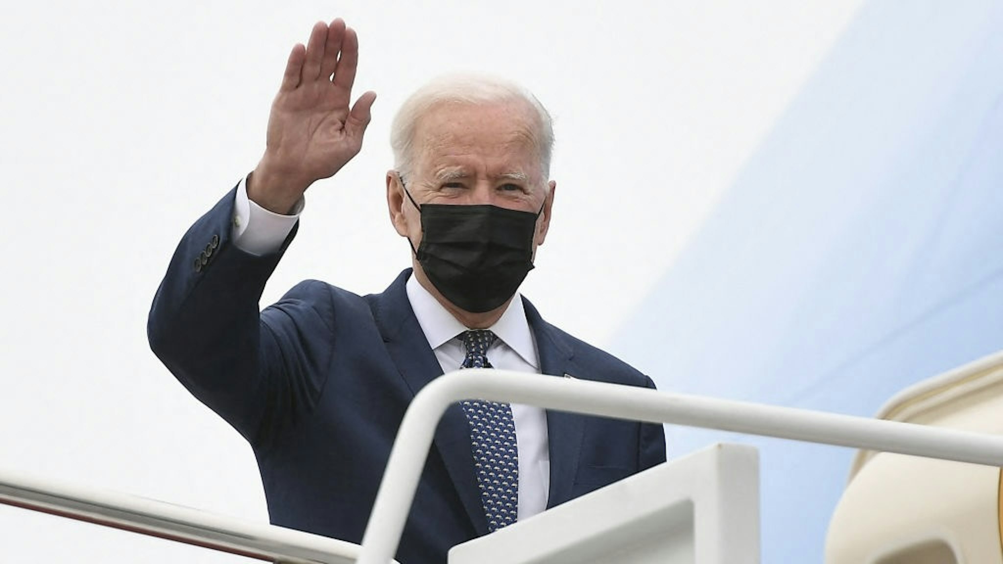 US President Joe Biden waves as he makes his way to board Air Force One before departing from Andrews Air Force Base in Maryland on May 3, 2021. - President Biden is visiting Virginia to promote his Getting America Back on Track Tour. (Photo by MANDEL NGAN / AFP) (Photo by MANDEL NGAN/AFP via Getty Images)