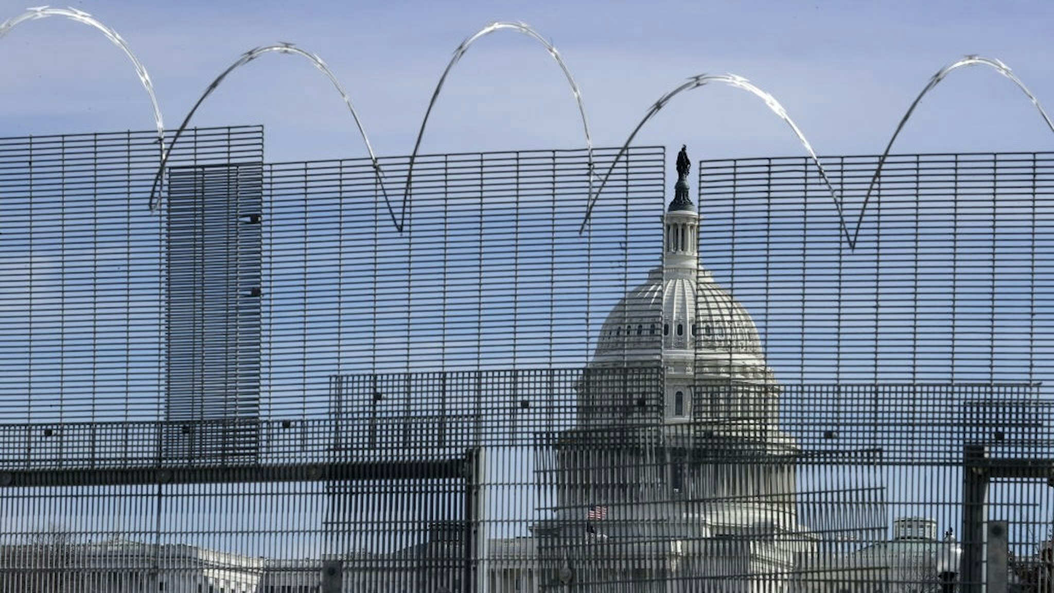 WASHINGTON, DC - FEBRUARY 17: A temporary security fence topped with concertina razor wire surrounds the U.S. Capitol on February 17, 2021 in Washington, DC. The fence was erected around the Capitol, the Supreme Court, the Library of Congress and their associated office buildings following the deadly January 6 insurrection, where thousands of supporters of former President Donald Trump stormed the Capitol in an attempt to halt certification of the 2020 presidential election results. (Photo by Chip Somodevilla/Getty Images)