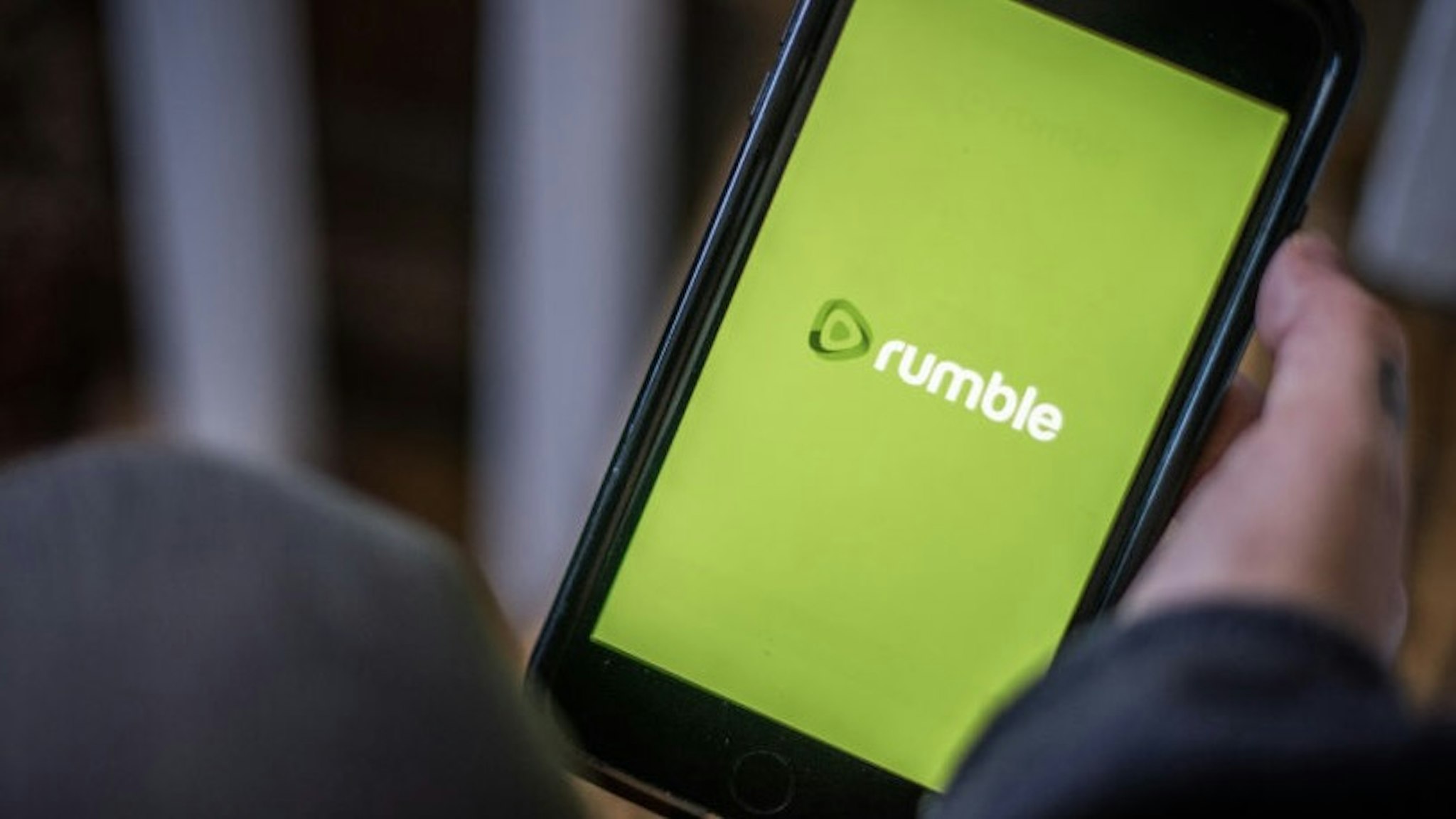 The Rumble video platform logo on a smartphone arranged in Hastings on Hudson, New York, U.S., on Saturday, Jan. 23, 2021. Big tech's decision to ban the Parler app and block former U.S. President Donald Trump is stoking support for alternative social networking sites and apps that bill themselves as promoting free speech and privacy. Photographer: Tiffany Hagler-Geard/Bloomberg via Getty Images