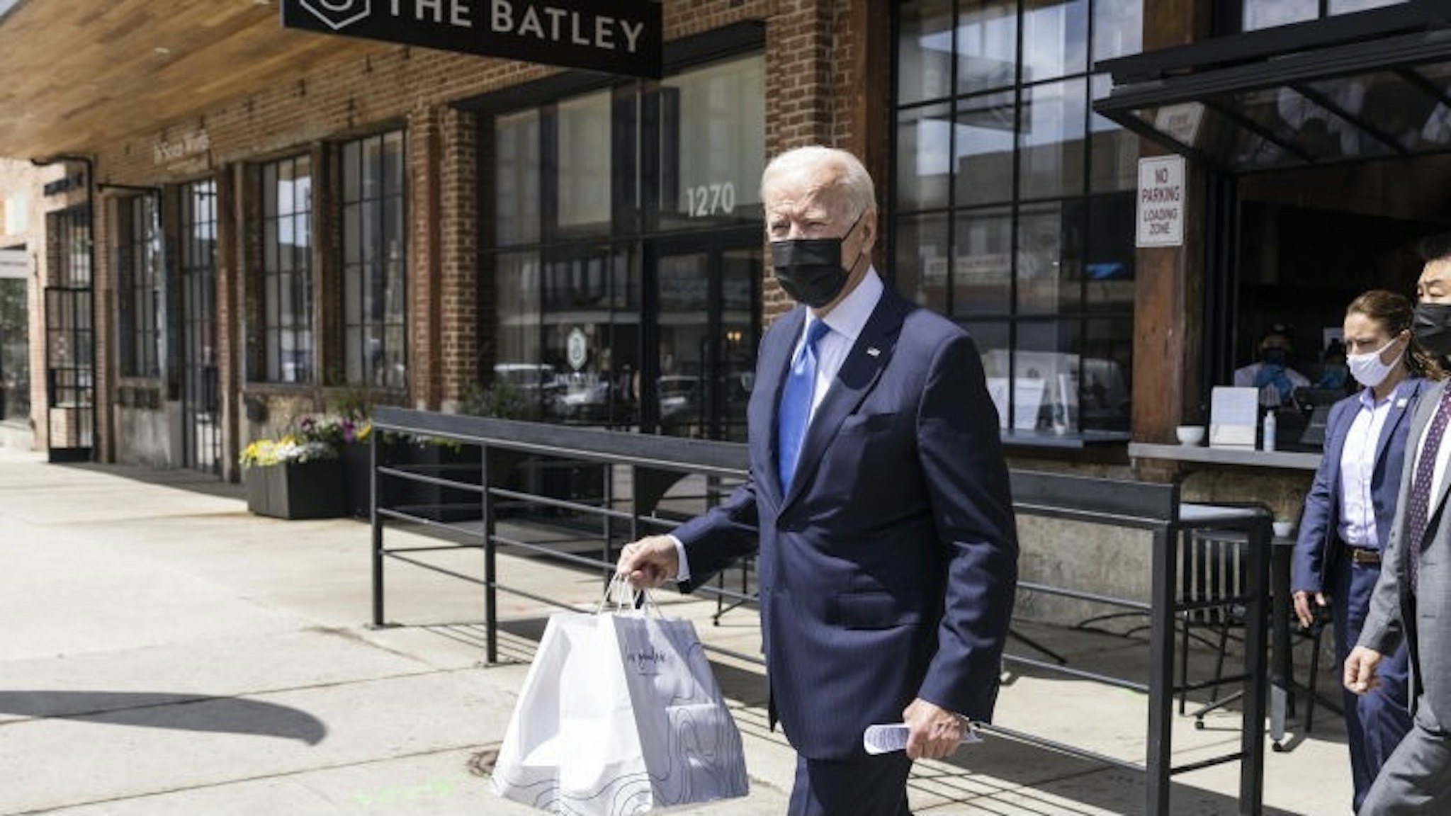 U.S. President Joe Biden wears a protective mask while carrying to-go food at Las Gemelas restaurant in Washington, D.C., U.S., on Wednesday, May 5, 2021. The Biden administration canceled a signature Trump-era rule that would've eased businesses ability to legally consider workers as independent contractors, a rollback the U.S. Labor Department said was necessary to broadly extend wage protections while cracking down on employer abuses. Photographer: Jim Lo Scalzo/EPA/Bloomberg