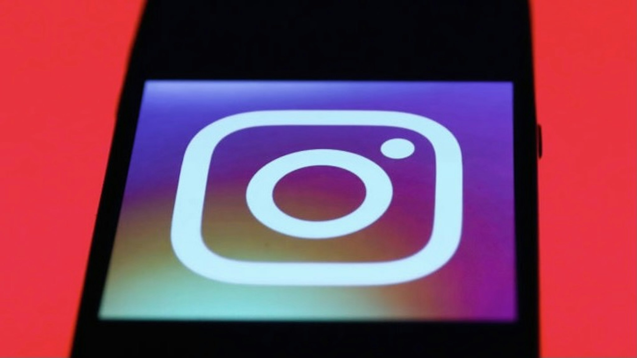 Instagram app icon is seen on the smartphone screen with covid-19sign in the background in this illustration photo taken in Poland on March 21, 2020. (Photo by Jakub Porzycki/NurPhoto)