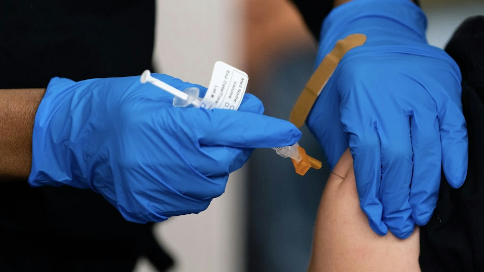 An attendee recieves a dose of the Pfizer-BioNTech Covid-19 vaccine during an Atlanta Braves baseball game at Truist Park in Atlanta, Georgia, U.S., on Friday, May 7, 2021. The Atlanta Braves will be providing free COVID-19 vaccinations for fans during their games Friday and Saturday against the Philadelphia Phillies. Each person who gets vaccinated is eligible to receive two free tickets to a future Braves game. Photographer: Elijah Nouvelage/Bloomberg