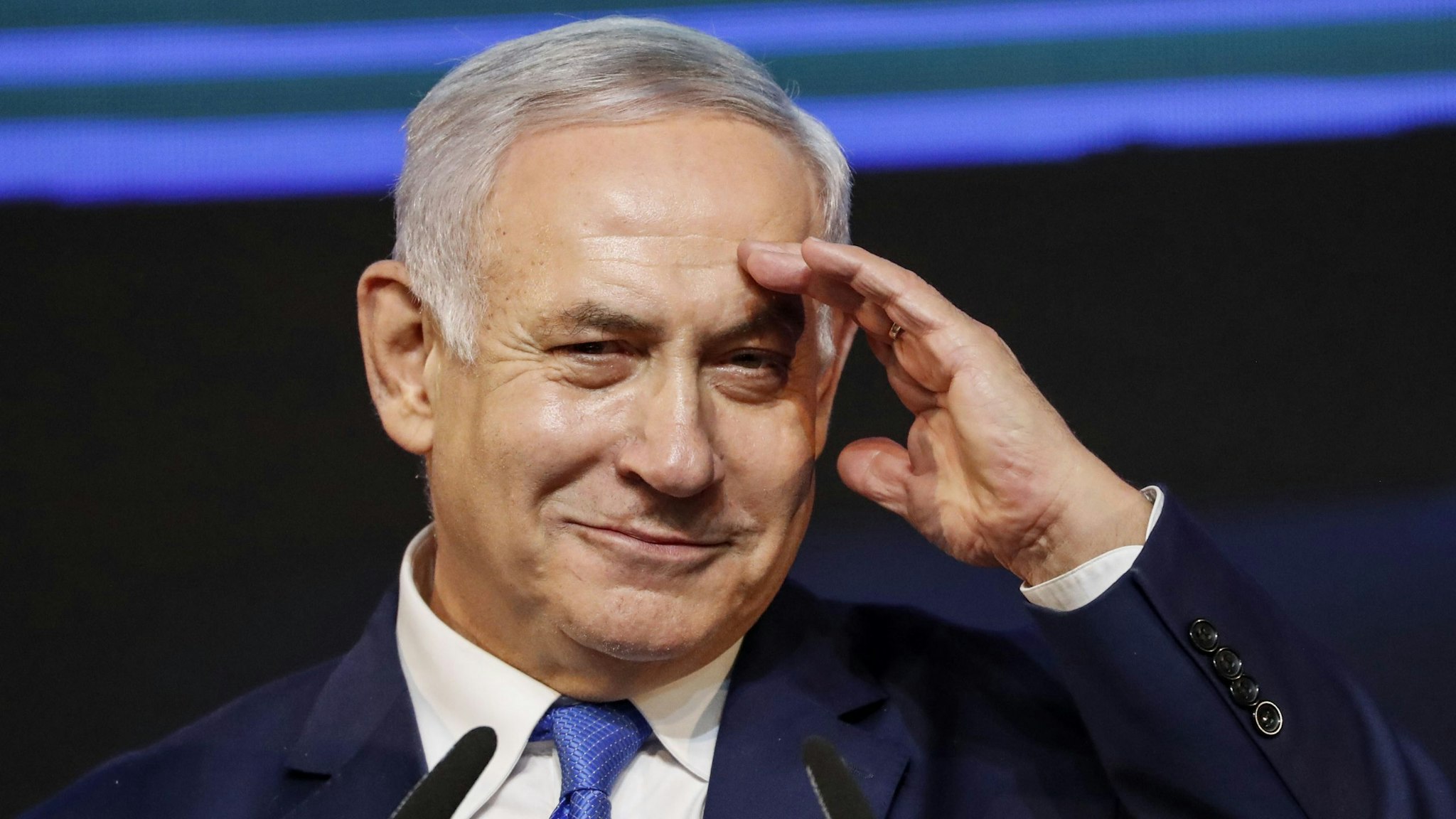 Israeli Prime Minister Benjamin Netanyahu gestures as he addresses supporters at his Likud Party headquarters in the Israeli coastal city of Tel Aviv on election night early on April 10, 2019.