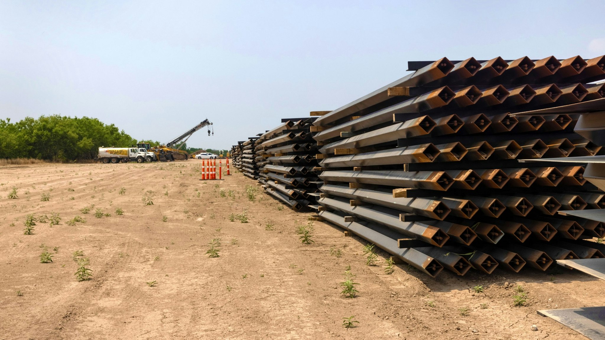 LA JOYA, TEXAS - APRIL 14: Unused pieces of steel bollard-style wall lay near a portion of unfinished border wall at the U.S.-Mexico border on April 14, 2021 in La Joya, Texas. President Joe Biden paused wall construction by executive order upon taking office in January, 2021. The administration has reportedly decided to possibly finish wall construction on gaps where the wall was largely completed.