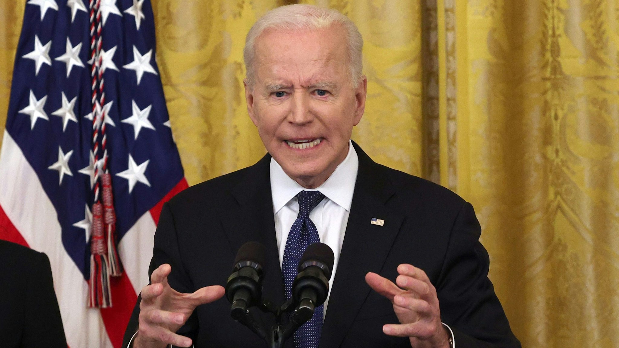 WASHINGTON, DC - MAY 20: U.S. President Joe Biden gestures as he delivers remarks, before a signing ceremony for the COVID-19 Hate Crimes Act in the East Room of the White House on May 20, 2021 in Washington, DC.  The legislation, drafted in response to the increased violence against the Asian American and Pacific Islander (AAPI) community during the Coronavirus pandemic, will create a new position in the Department of Justice to focus on the rise in hate crimes and provide resources to federal, state, and local jurisdictions to better report cases.