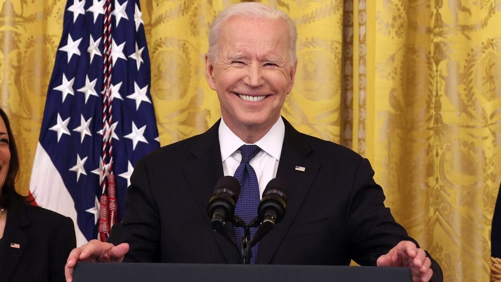 WASHINGTON, DC - MAY 20: U.S. President Joe Biden laughs while giving remarks, as Vice President Kamala Harris looks on, before a signing ceremony for the COVID-19 Hate Crimes Act in the East Room of the White House on May 20, 2021 in Washington, DC. The legislation, drafted in response to the increased violence against the Asian American and Pacific Islander (AAPI) community during the Coronavirus pandemic, will create a new position in the Department of Justice to focus on the rise in hate crimes and provide resources to federal, state, and local jurisdictions to better report cases.