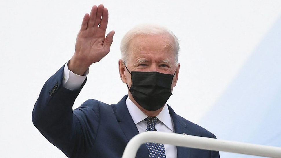 US President Joe Biden waves as he makes his way to board Air Force One before departing from Andrews Air Force Base in Maryland on May 3, 2021. - President Biden is visiting Virginia to promote his Getting America Back on Track Tour.