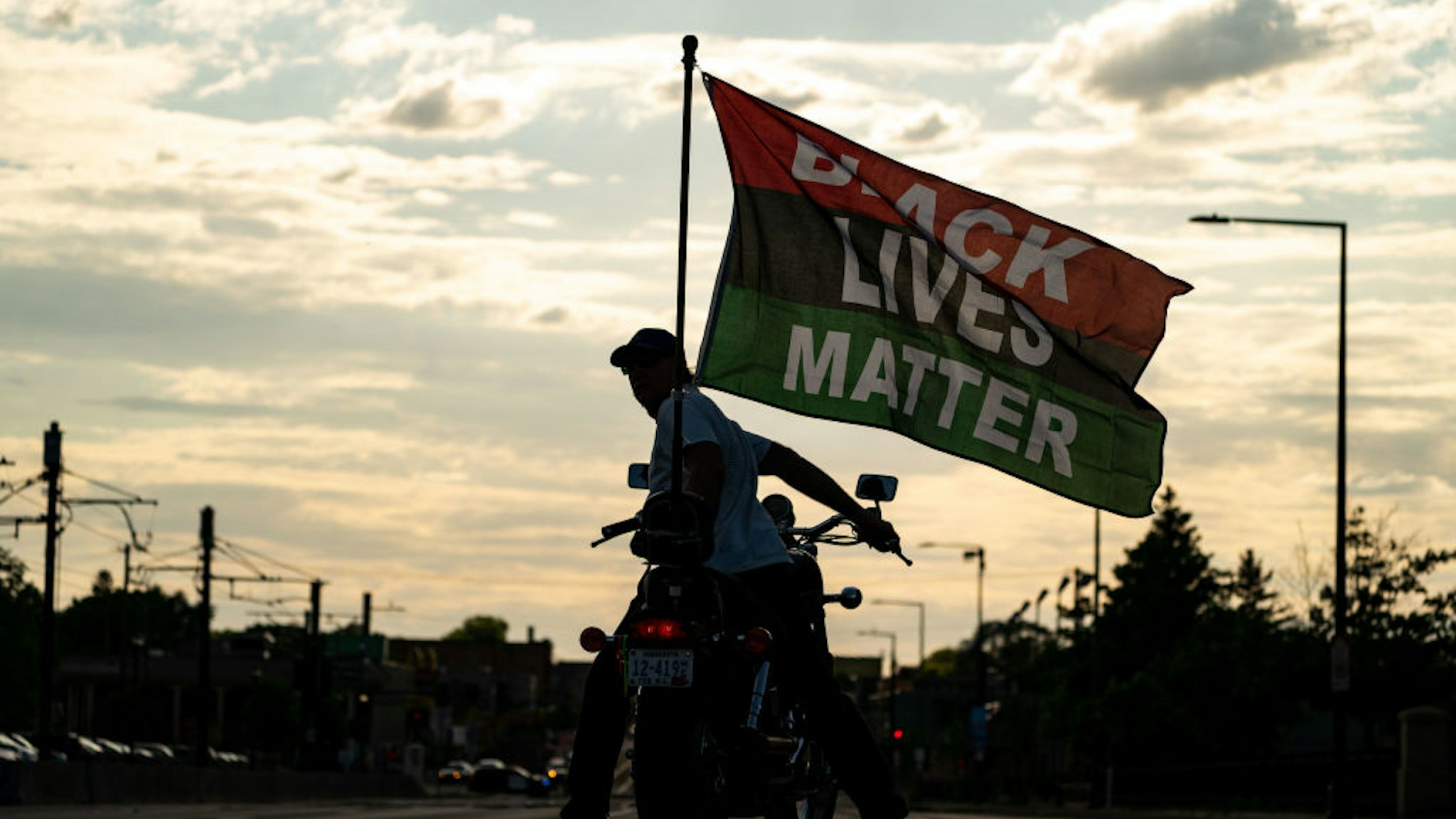 ST. PAUL, MN - MAY 24: A man on a motorcycle displays a Black Lives Matter flag during a march and rally at the Minnesota State Capitol on Monday, May 24, 2021 in St. Paul, MN.