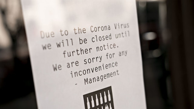 A sign alerts bar customers that it is closed due to the coronavirus outbreak in Washington, D.C., U.S., on Tuesday, March 17, 2020. The Trump administration is backing sending direct payments of $1,000 or more to Americans within two weeks as part of an $850 billion plan to blunt some of the economic impact of the widening coronavirus outbreak.