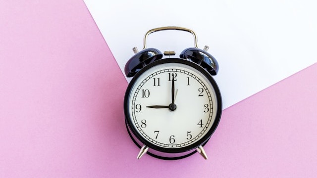 Alarm Clock on Multi Colored Background - stock photo Nora Carol Photography via Getty Images
