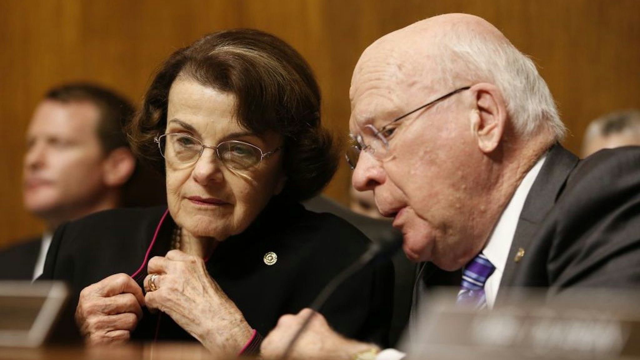 Senator Dianna Feinstein (D-CA) and Senator Patrick Leahy (D-VT) chat as Dr. Christine Blasey Ford speaks at the Senate Judiciary Committee hearing on the nomination of Brett Kavanaugh to be an associate justice of the Supreme Court of the United States, on Capitol Hill in Washington, DC, on September 27, 2018. (Photo by MICHAEL REYNOLDS / POOL / AFP) (Photo by MICHAEL REYNOLDS/POOL/AFP via Getty Images)