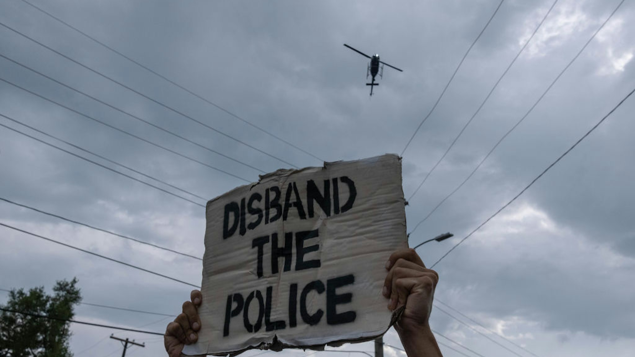 Non-Violent protesters march against police brutality near Detroit's west side as a Detroit police department helicopter fly's overhead. 20-year-old Hakeem Littleton was shot and killed by Detroit Police earlier in the day, July 10,2020.