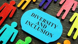Diversity and inclusion Diversity and inclusion phrase and colored wooden figurines.
