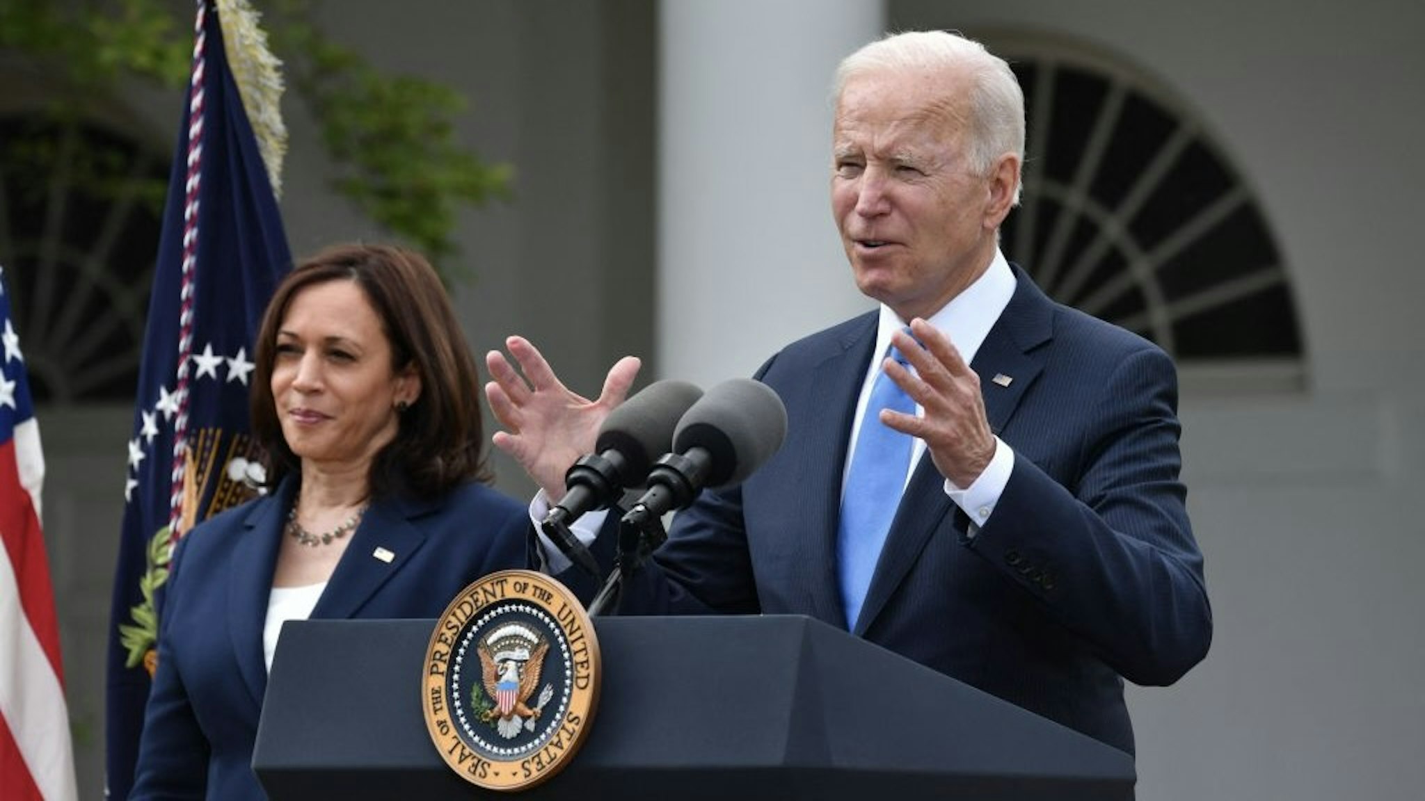 US Vice President Kamala Harris looks on as US President Joe Biden delivers remarks on Covid-19 response and the vaccination program, from the Rose Garden of the White House, Washington, DC on May 13, 2021. (Photo by Nicholas Kamm / AFP) (Photo by NICHOLAS KAMM/AFP via Getty Images)