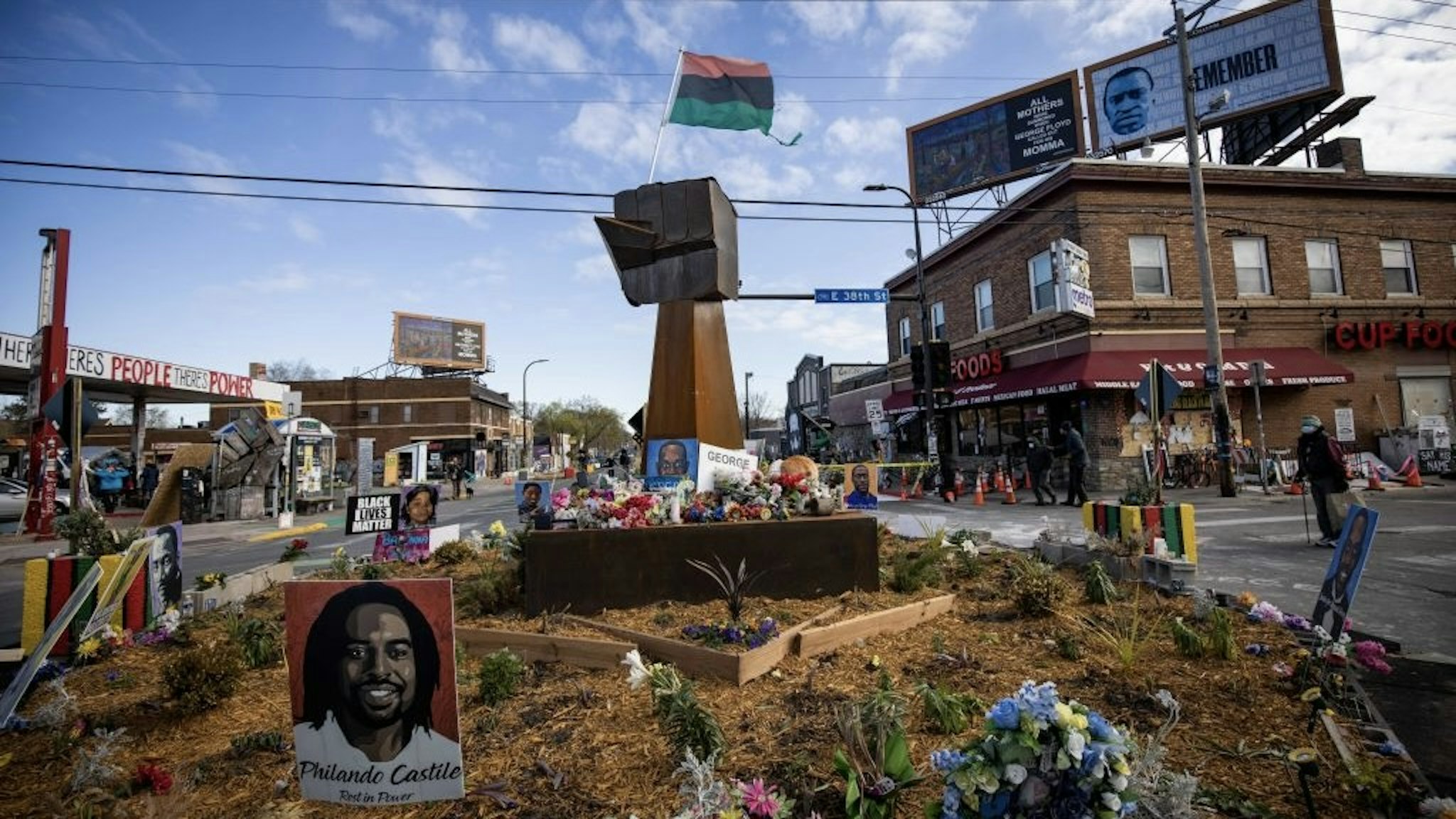 Jury Begins Deliberation In Former Officer Chauvin Murder Trial A Pan-African flag flies above a wooden fist statue at George Floyd Square in Minneapolis, Minnesota, U.S., on Tuesday, April 20, 2021. The case of the former Minneapolis police officer accused of killing George Floyd went to the jury after Derek Chauvin's defense attorney said the viral video of him kneeling on Floyd's neck and back doesn't tell the entire story. Photographer: Christian Monterrosa/Bloomberg Bloomberg / Contributor via Getty Images