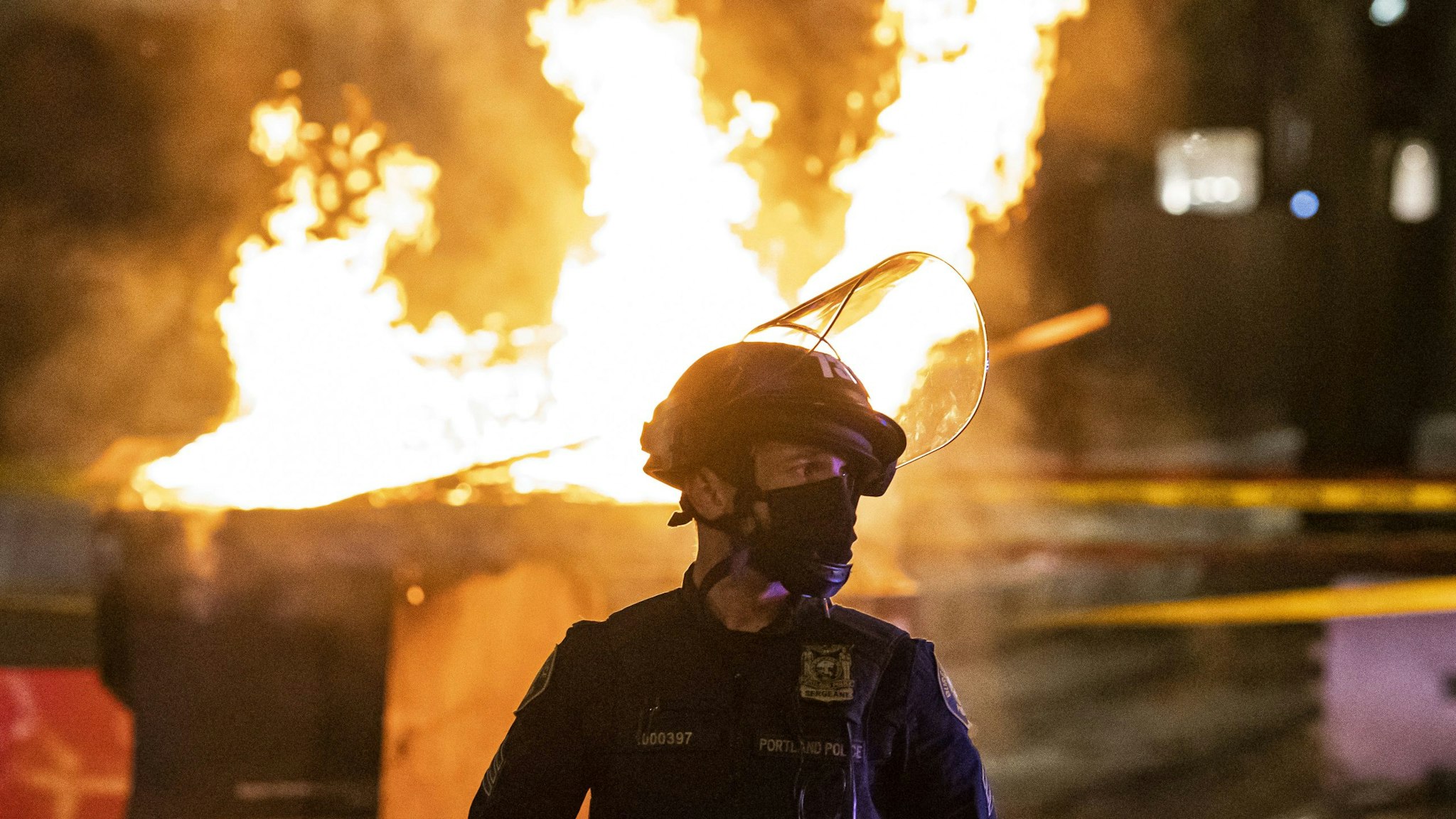 PORTLAND, OR - APRIL 17: Portland Police responds to a structure fire, set by protesters following the police shooting of a homeless man on April 17, 2021 in Portland, Oregon. The shooting comes amid heightened tensions between police and activists as the country awaits a verdict in the trial of Derek Chauvin.