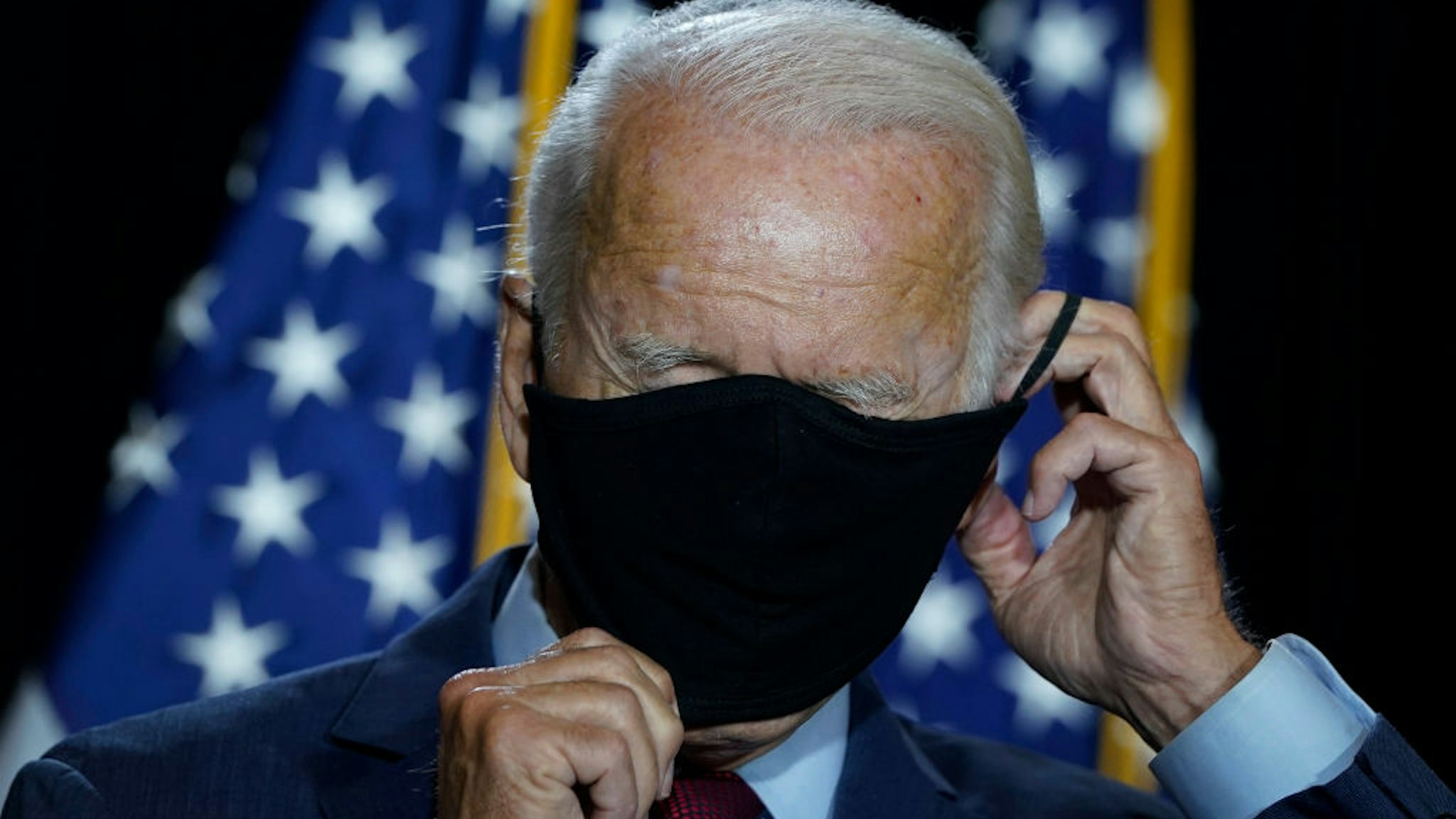 WILMINGTON, DE - AUGUST 13: Presumptive Democratic presidential nominee former Vice President Joe Biden puts his mask back on after delivering remarks following a coronavirus briefing with health experts at the Hotel DuPont on August 13, 2020 in Wilmington, Delaware. Harris is the first Black woman and first person of Indian descent to be a presumptive nominee on a presidential ticket by a major party in U.S. history.