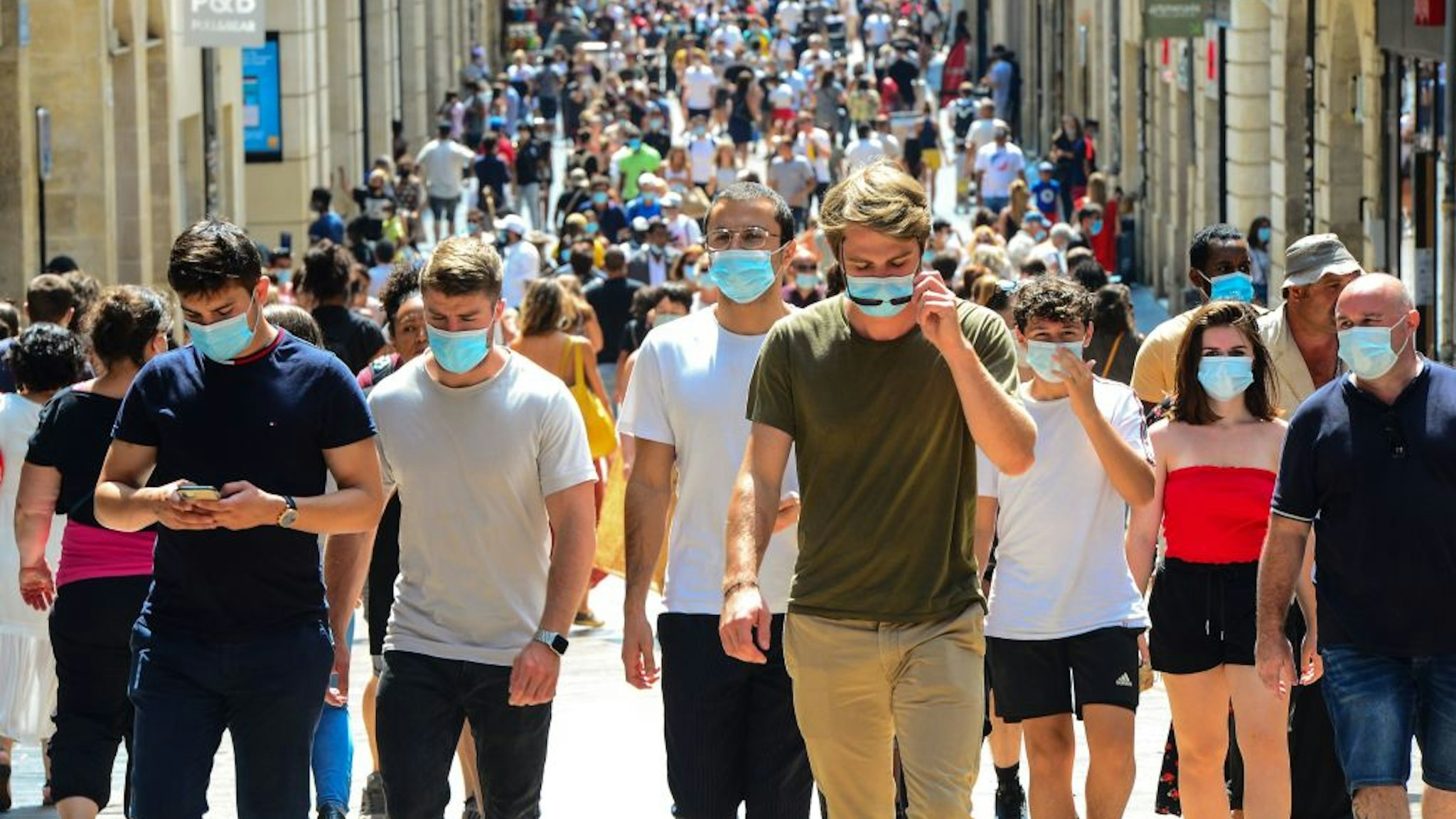 TOPSHOT - People stroll down Bordeaux's main shopping street Sainte-Catherine, where wearing a mask is compulsory as of August 15, 2020, to prevent the spread of the novel coronavirus COVID-19. - The fine for non-compliance with wearing a mask is 135 euros. The Mayor of the southwestern city of Bordeaux Pierre Hurmic, has made it compulsory to wear a mask in Sainte-Catherine and Porte-Dijeaux streets as of from August 15. (Photo by MEHDI FEDOUACH / AFP) (Photo by MEHDI FEDOUACH/AFP via Getty Images)