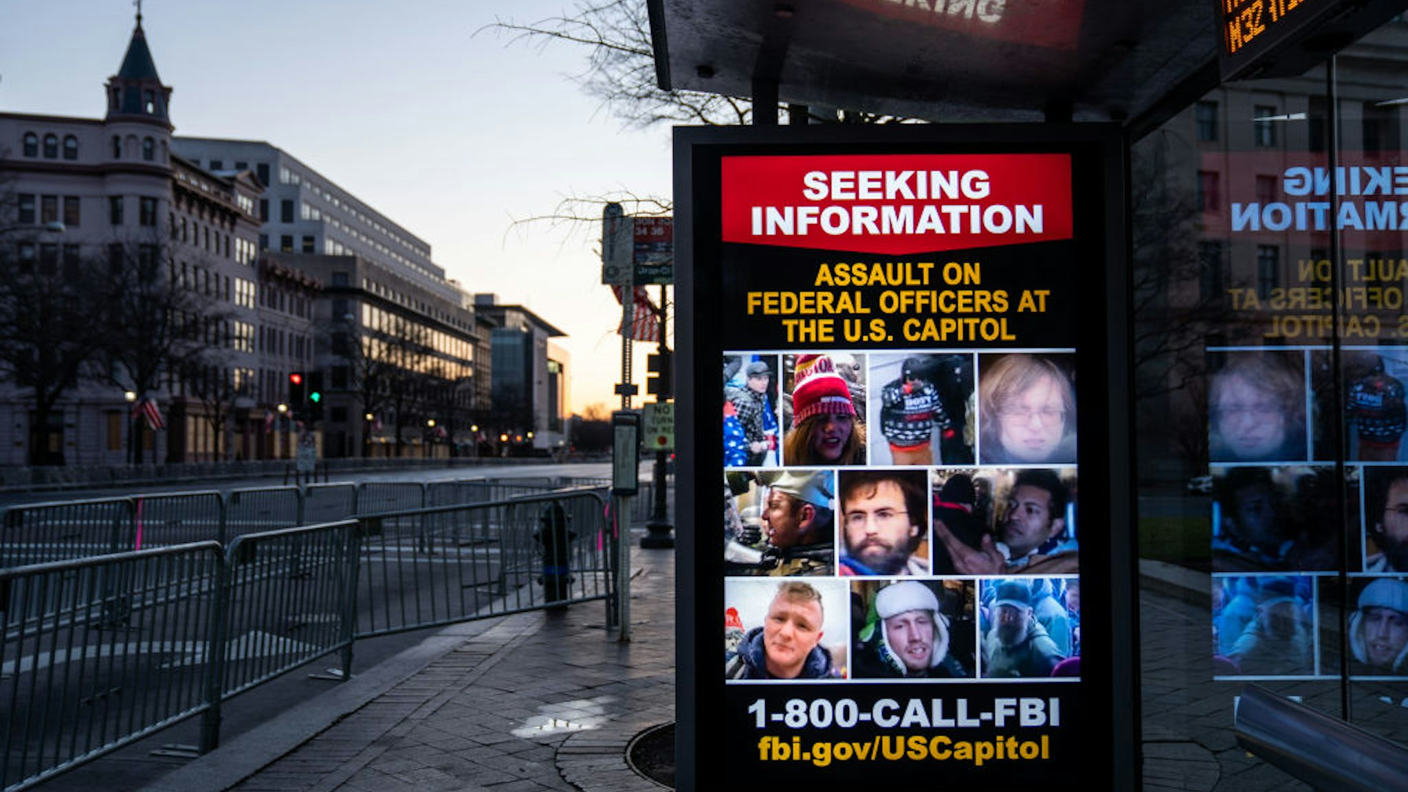 WASHINGTON, DC - JANUARY 16: A sign seeking information about people who breached the Capitol building is seen as the sun rises behind, seen from Pennsylvania Ave., which is within the secure area around downtown Washington DC on Saturday, Jan. 16, 2021 in Washington, DC. After last week's riots and security breach at the U.S. Capitol Building, the FBI has warned of additional threats in the nation's capital and across all 50 states.