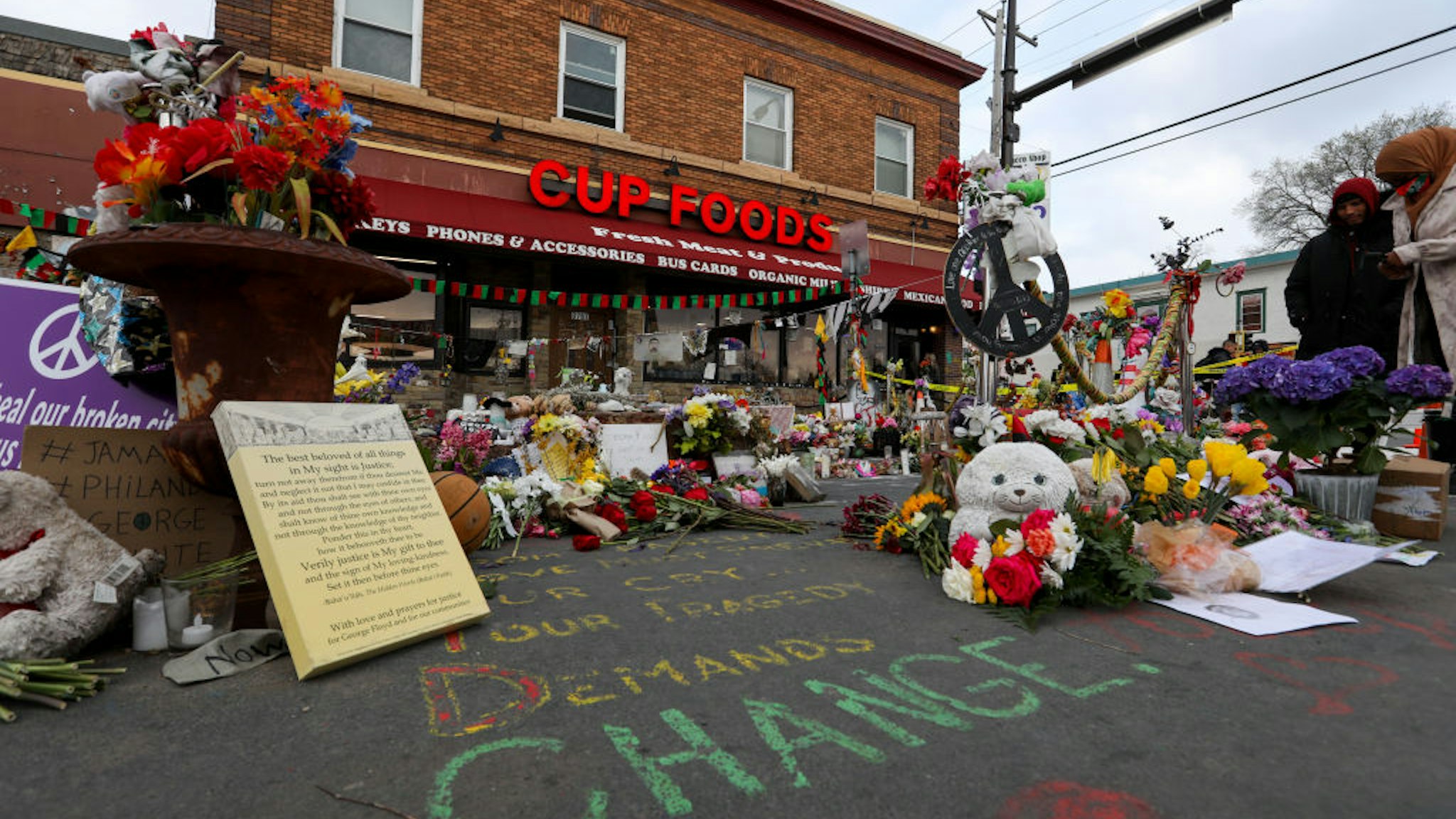 People lay flowers at a memorial in George Floyd Square in Minneapolis, Minnesota, United States on April 21, 2021. George Floyd by the Cup Foods where he was killed by Minneapolis Police Officer Derek Chauvin in Minneapolis, Minnesota.