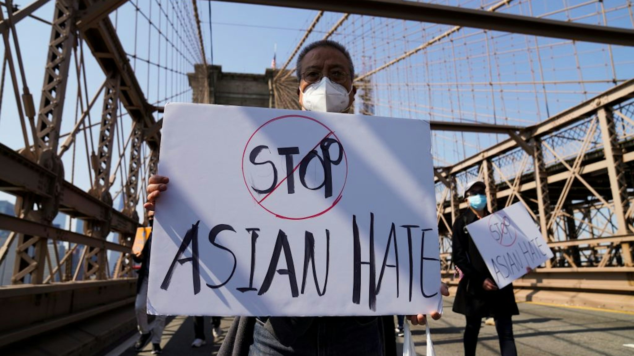 People march to protest against anti-Asian hate crimes on Brooklyn Bridge in New York, the United States, April 4, 2021.